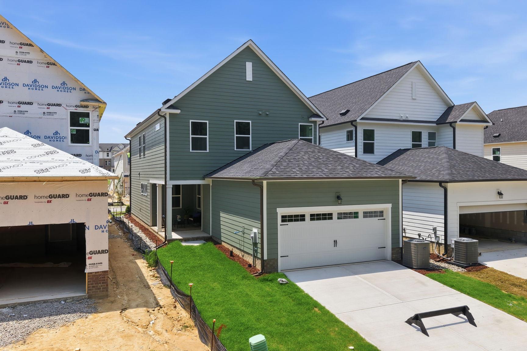 Exterior view of The Jordan A two-story single-family home by Davidson Homes in Knightdale featuring a two-car garage.
