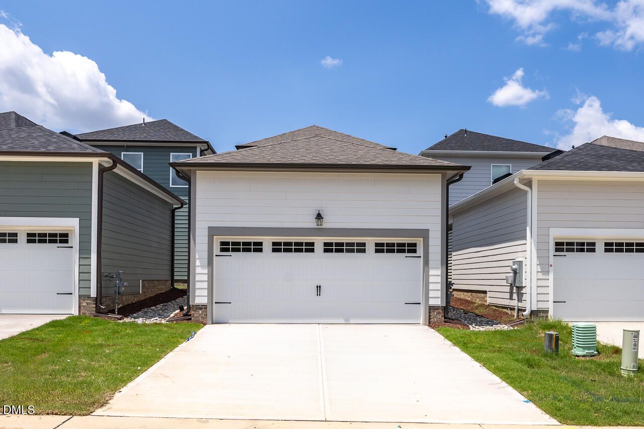 Two-car garage exterior of The Alexander C floor plan by Davidson Homes in Forestville Yard, Knightdale, North Carolina.