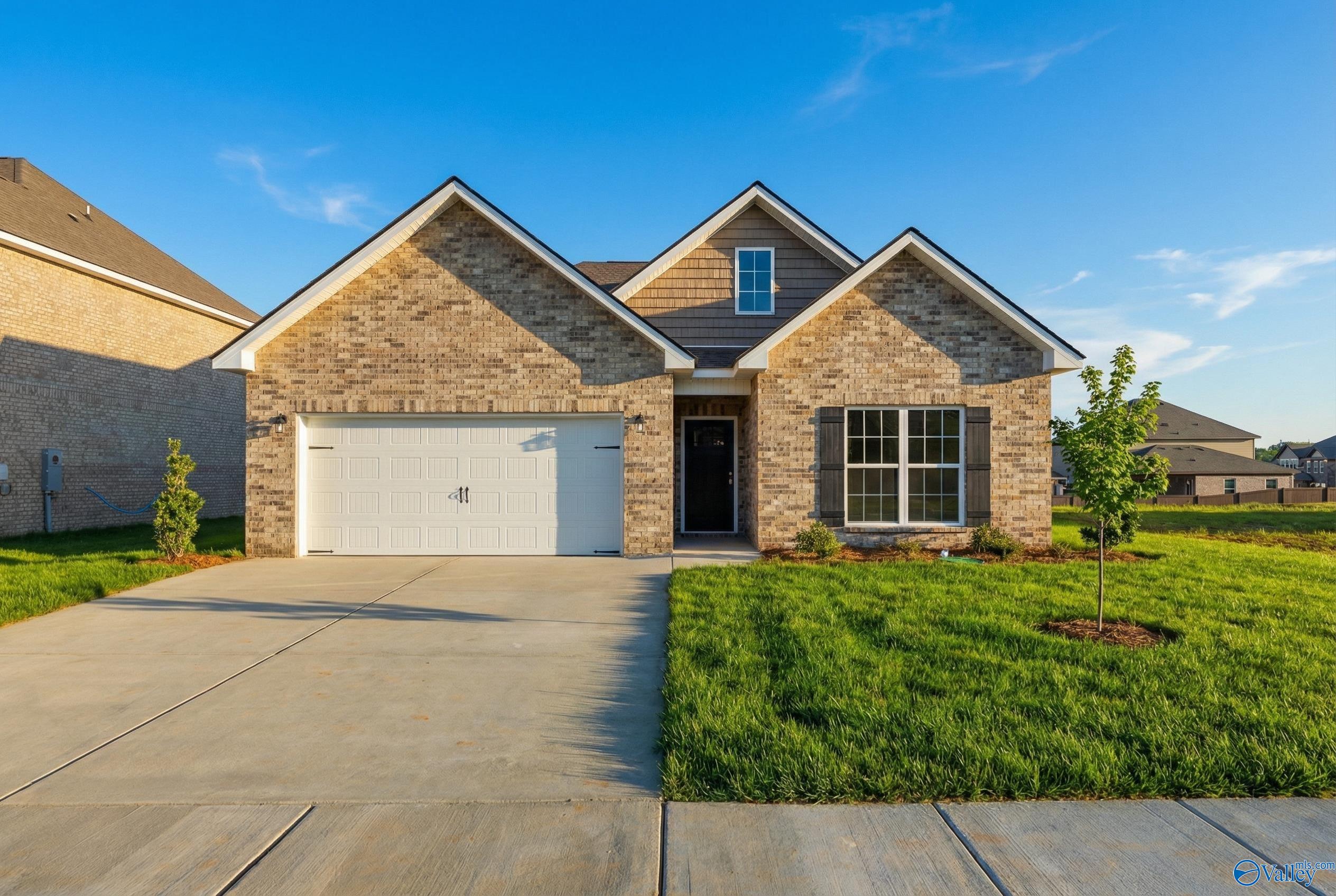 Modern single-story brick home with 2-car garage, driveway, and lush front lawn in Creek Grove, New Market, Alabama - The Franklin C by Davidson Homes