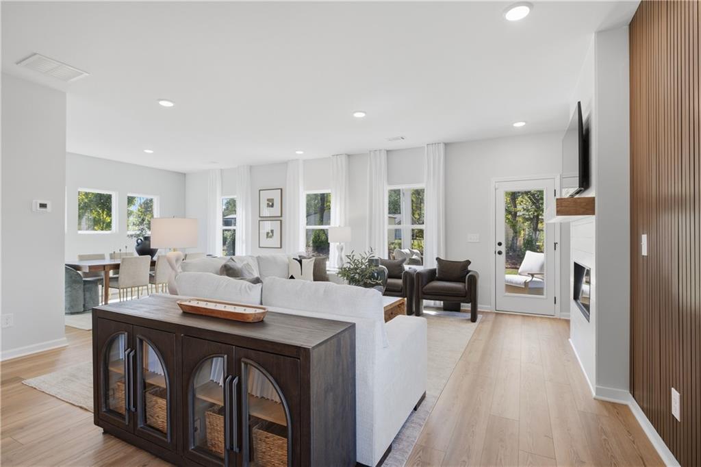Bright open-concept living room with hardwood floors and fireplace in Davidson Homes The Sinclair B, Greene Farm, Cartersville, GA