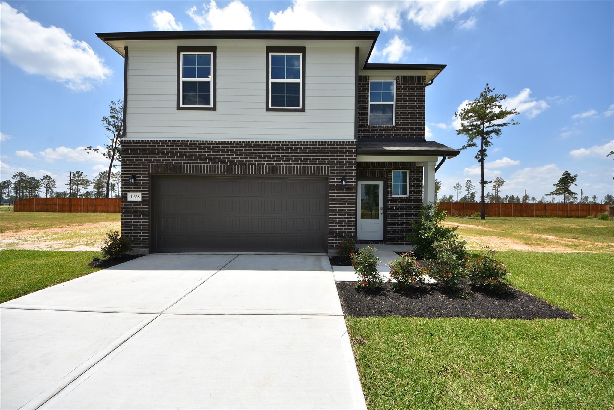 Two-story, 4-bedroom Davidson Homes Blanco F floor plan with a 2-car garage in Spring Branch Crossing, Conroe, Texas.