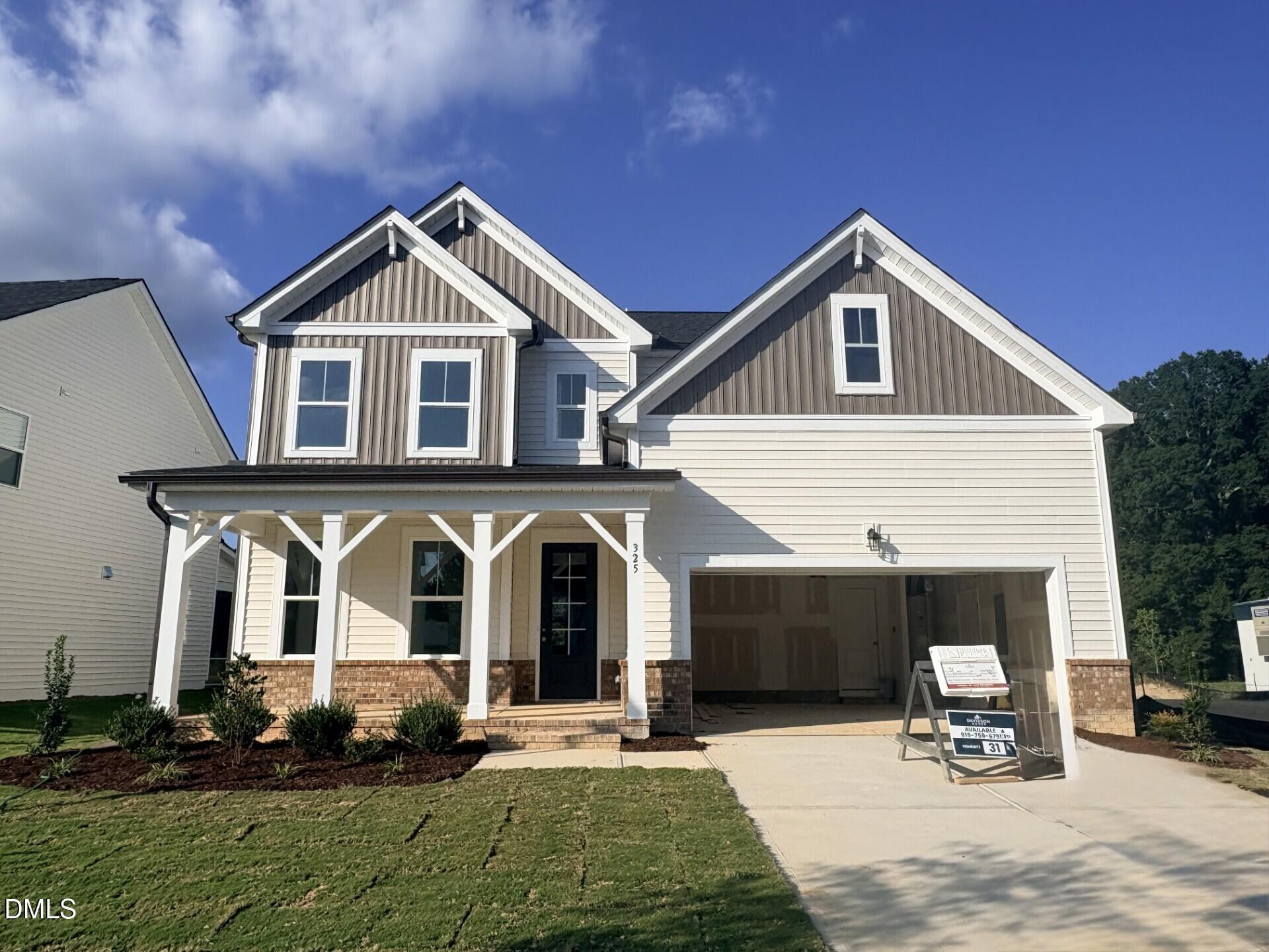 Front exterior of Davidson Homes' The Hickory II B, 2-story new home with covered porch and 2-car garage in Zebulon, NC