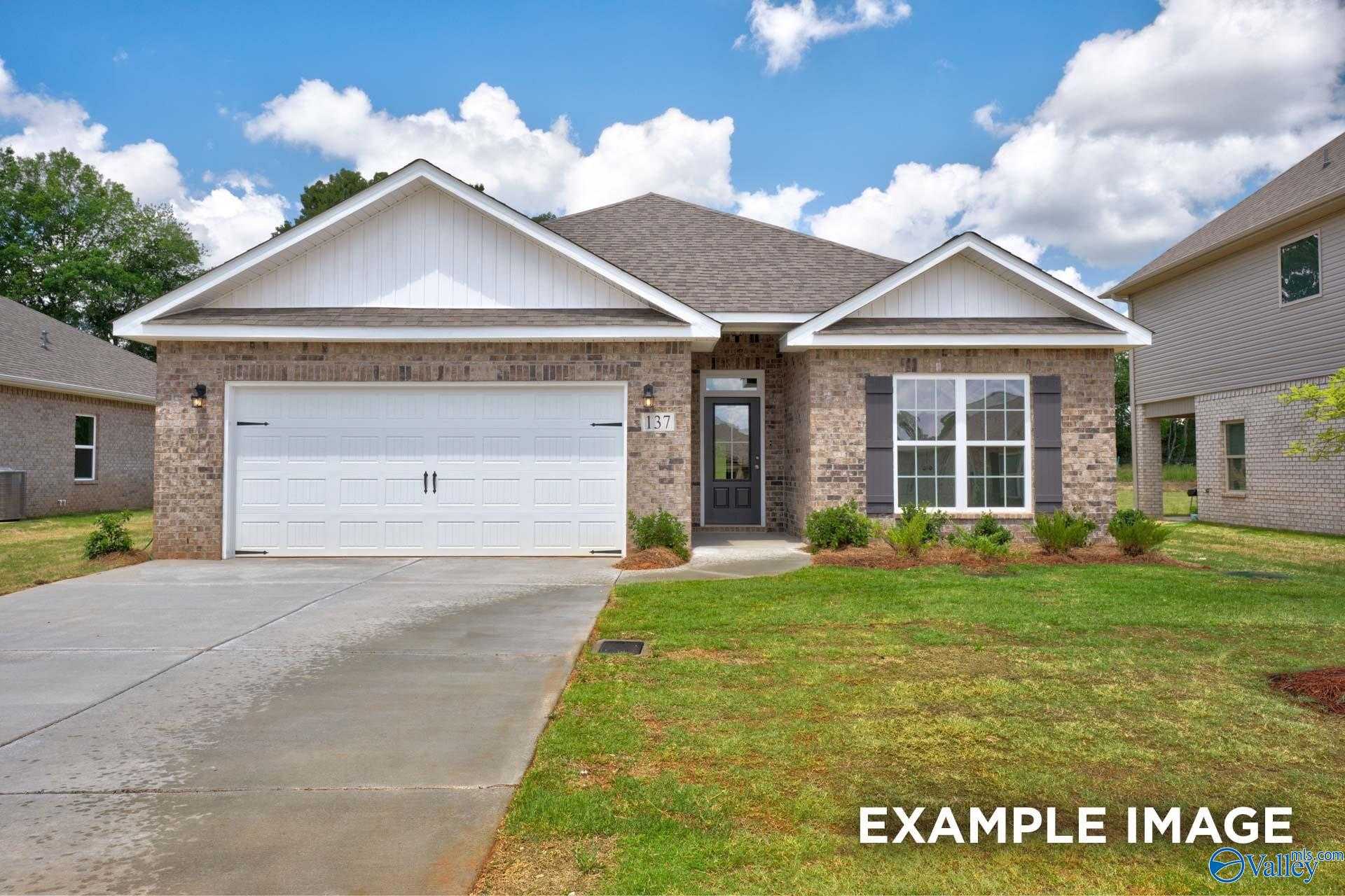 Brick ranch-style 4-bedroom home with 2-car garage, driveway, and landscaped yard in Creekside, Harvest, Alabama - Davidson Homes Everett