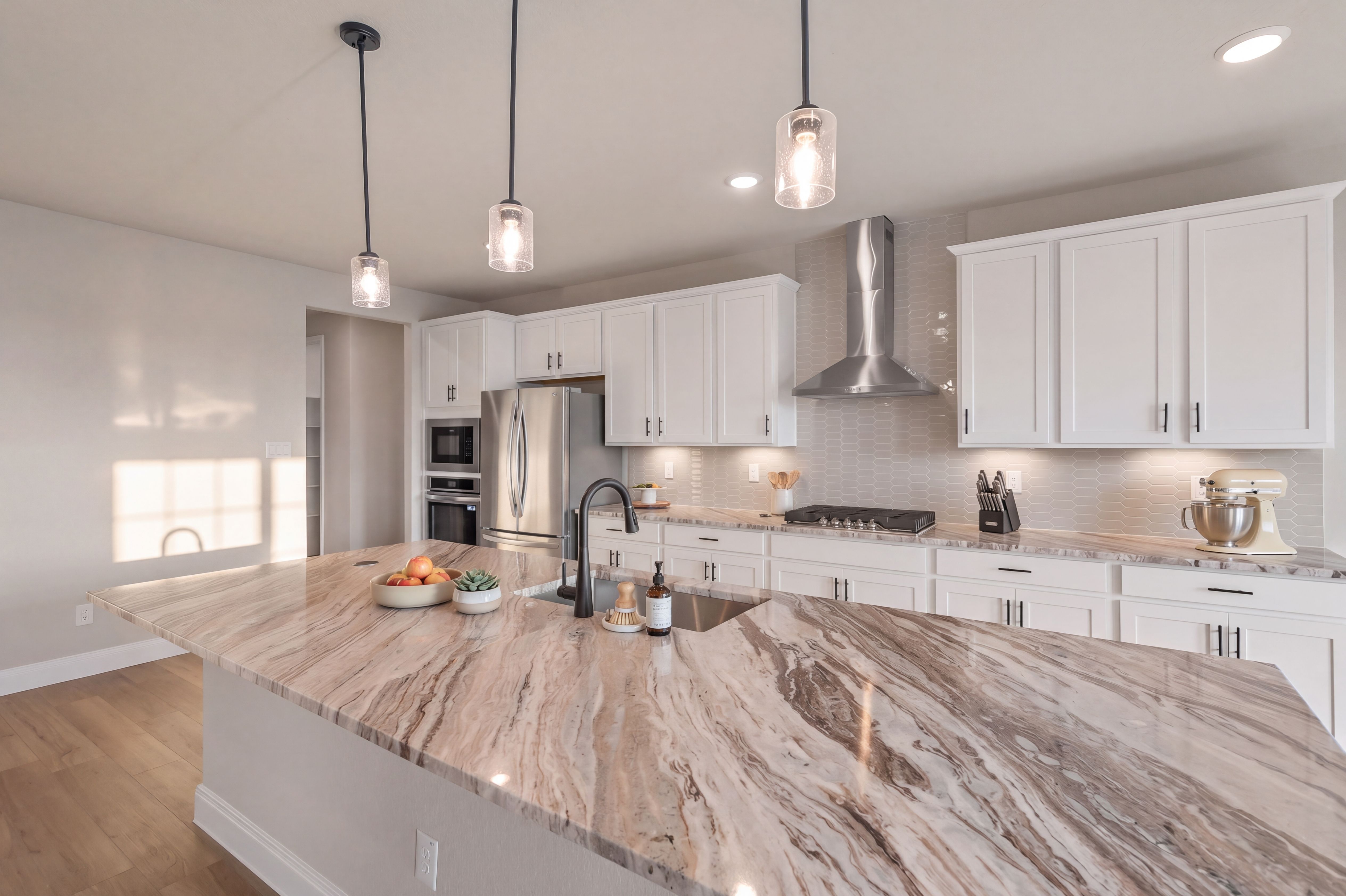 Large granite island and white cabinets at Potranco Oaks in Castroville, TX