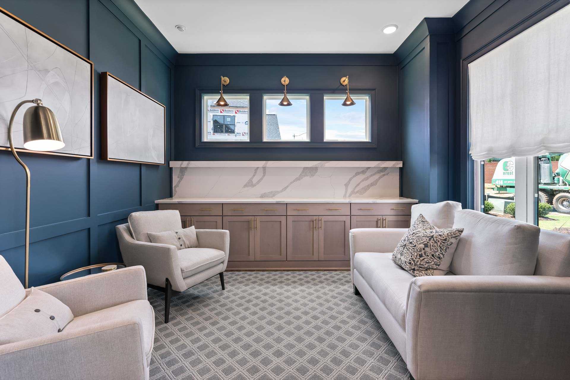 Modern lounge in Tanglewood East Cobb GA with navy walls, beige sofa and armchairs, quartz bar, pendant lights