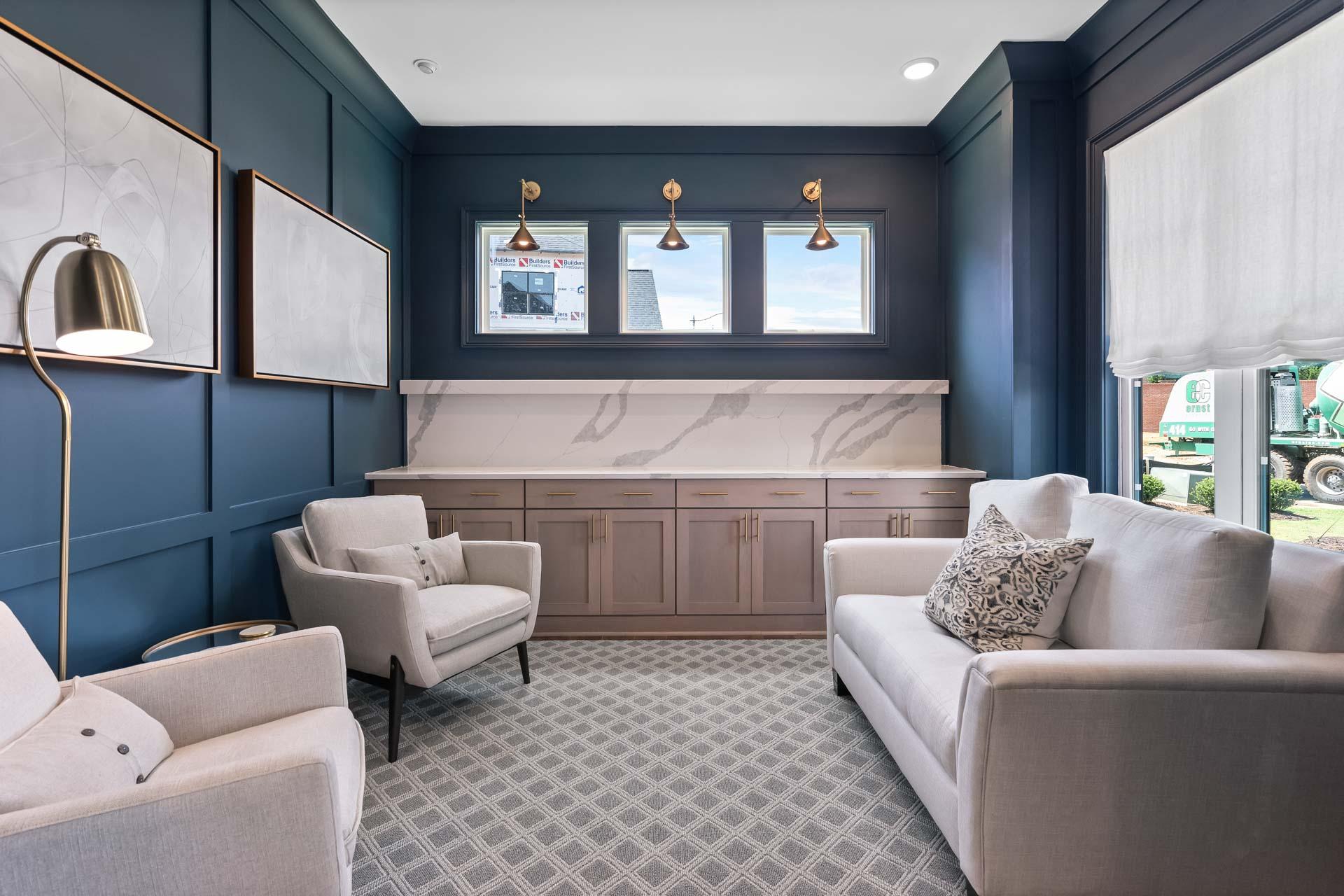 Modern lounge in Tanglewood East Cobb GA with navy walls, beige sofa and armchairs, quartz bar, pendant lights