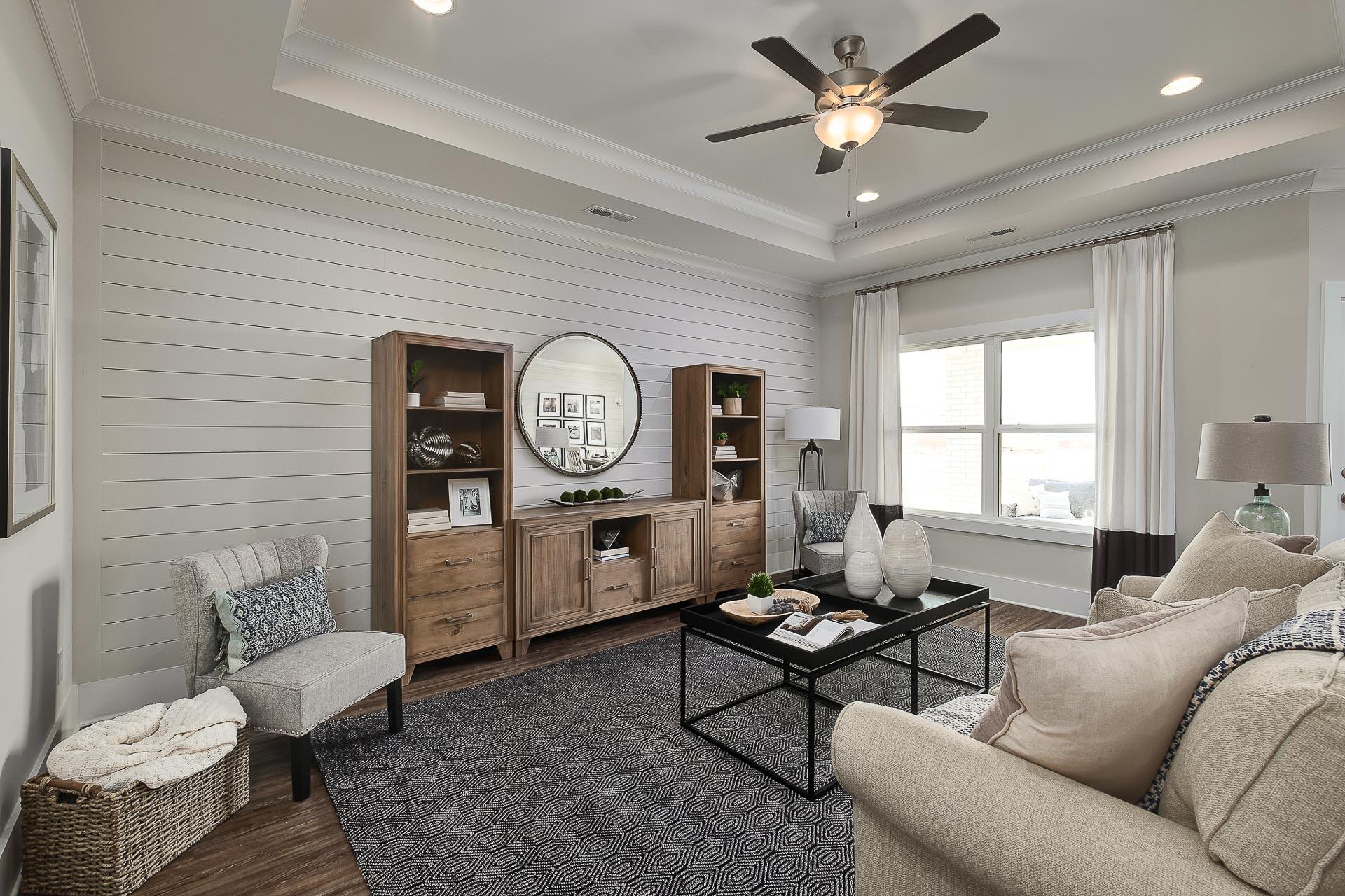 great room featuring double windows and tray ceiling in Cullman, AL at The Reserve at North Ridge