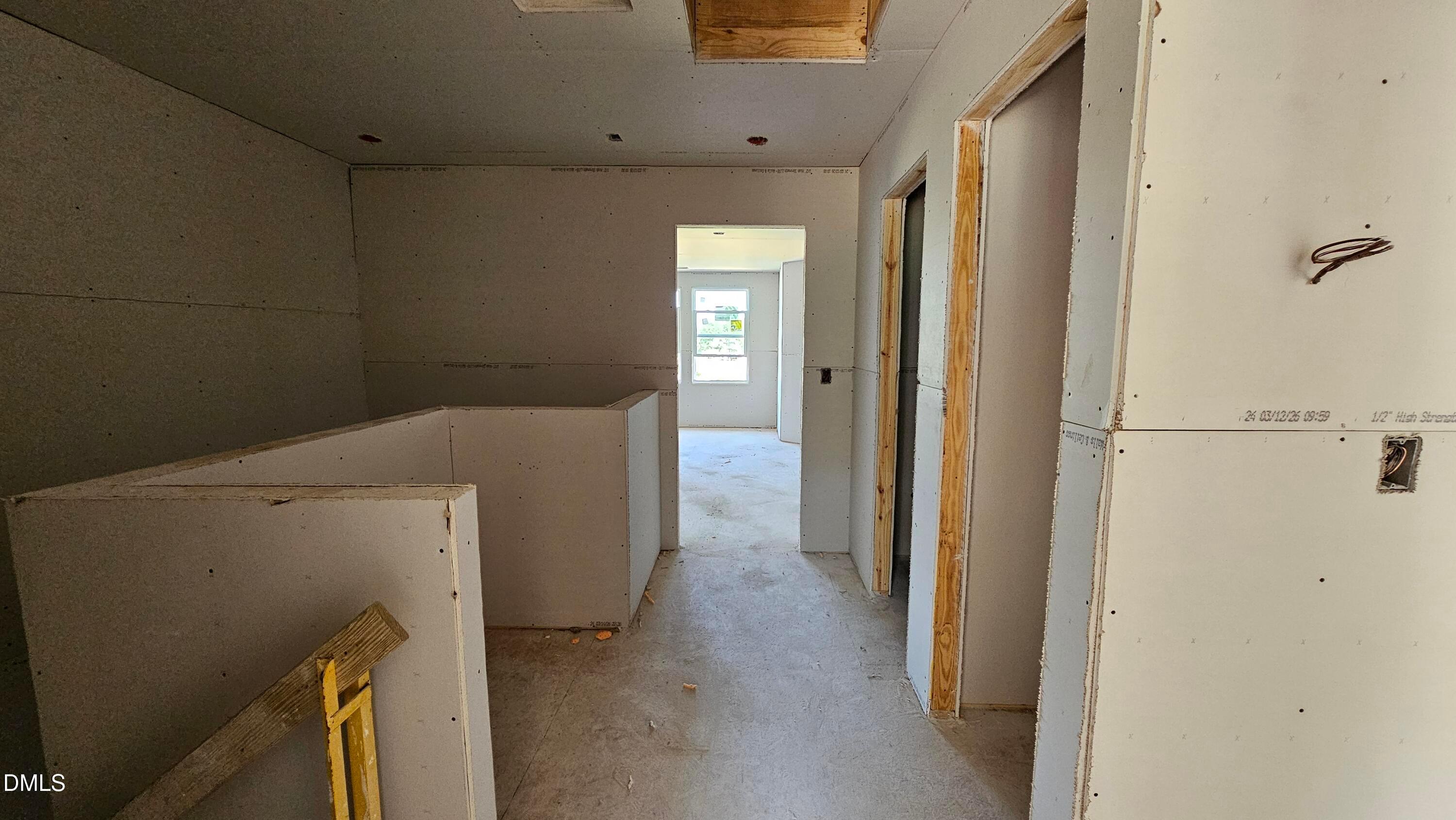 Unfinished interior of The Graham floor plan at Springvale in Fuquay-Varina, showing drywall installation and hallway.