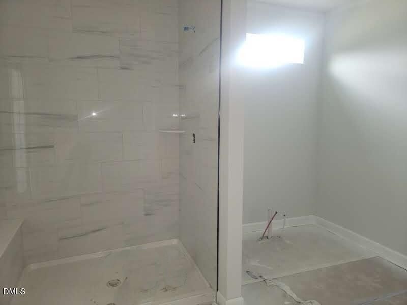 Walk-in tiled shower in master bathroom of The Crawford D floor plan by Davidson Homes in Angier, North Carolina.