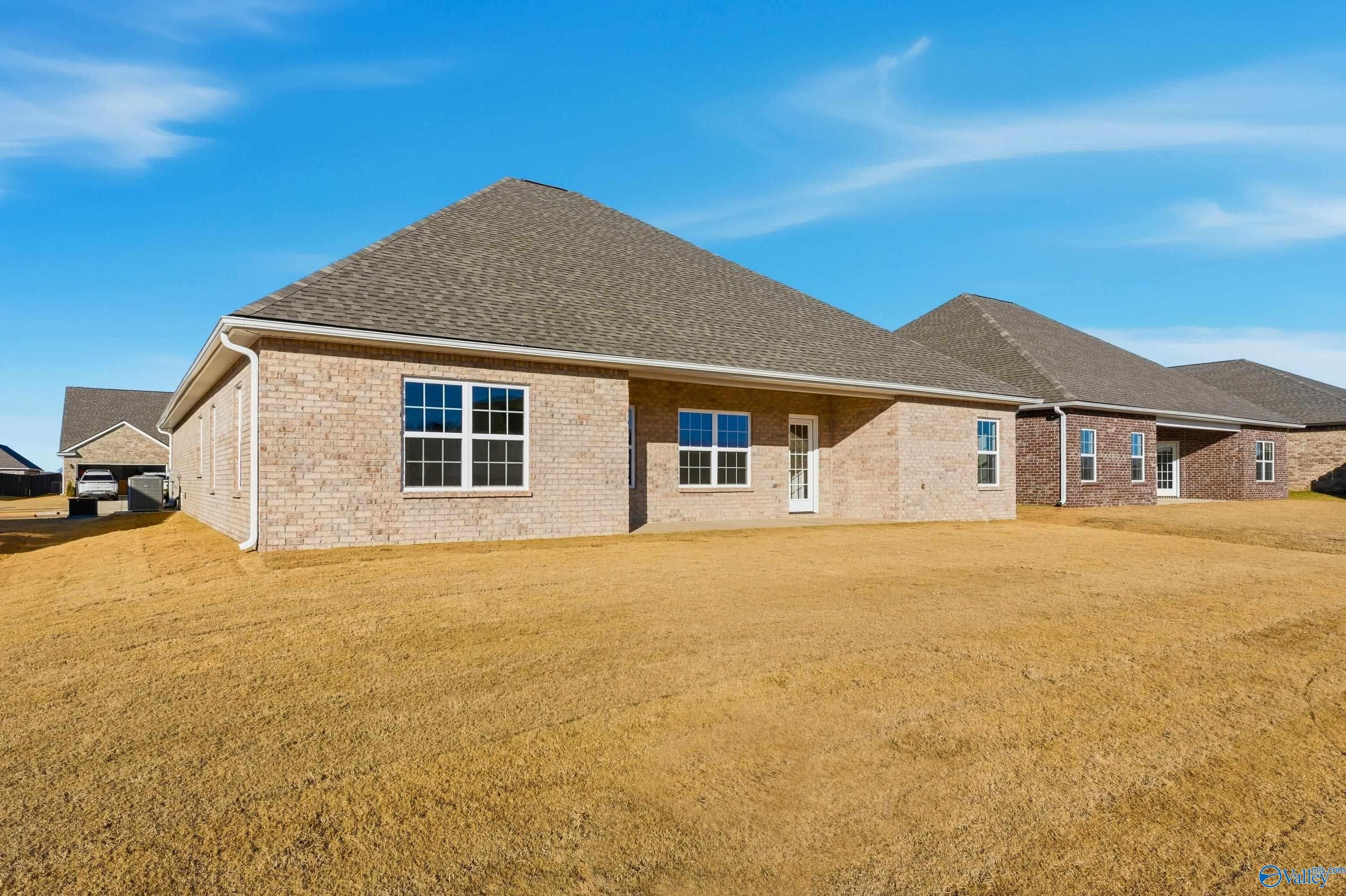 Single-story brick home exterior with gabled roof and covered entry in Kendall Downs, Toney, Alabama