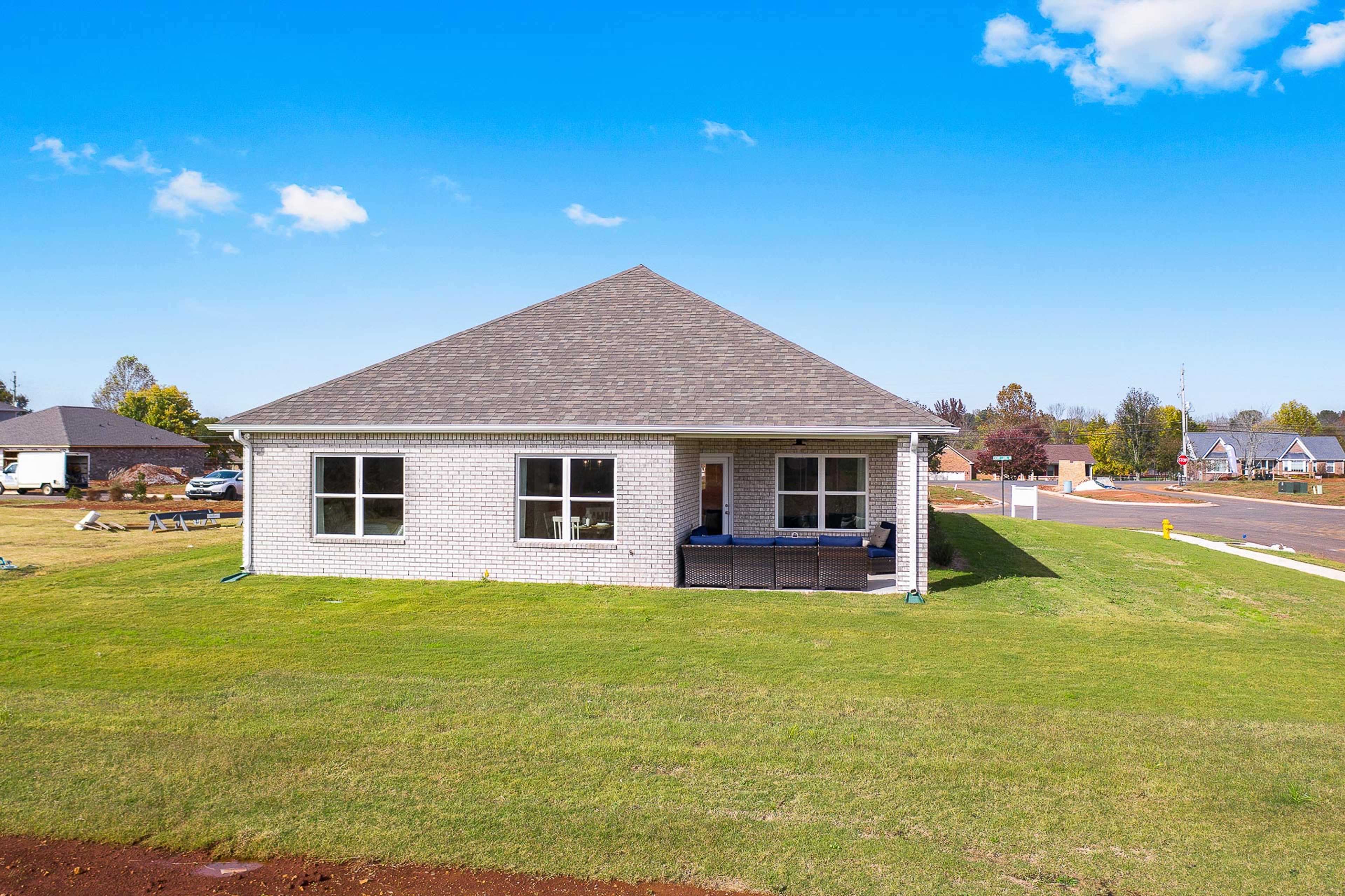 The Everett plan featuring light-colored brick and rear covered patio