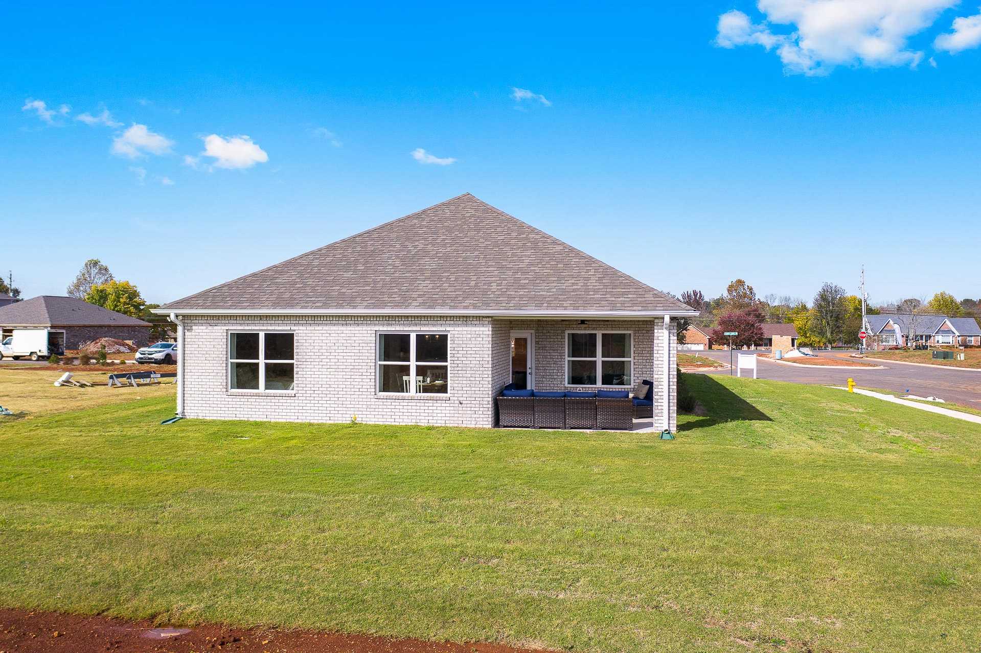 The Everett plan featuring light-colored brick and rear covered patio