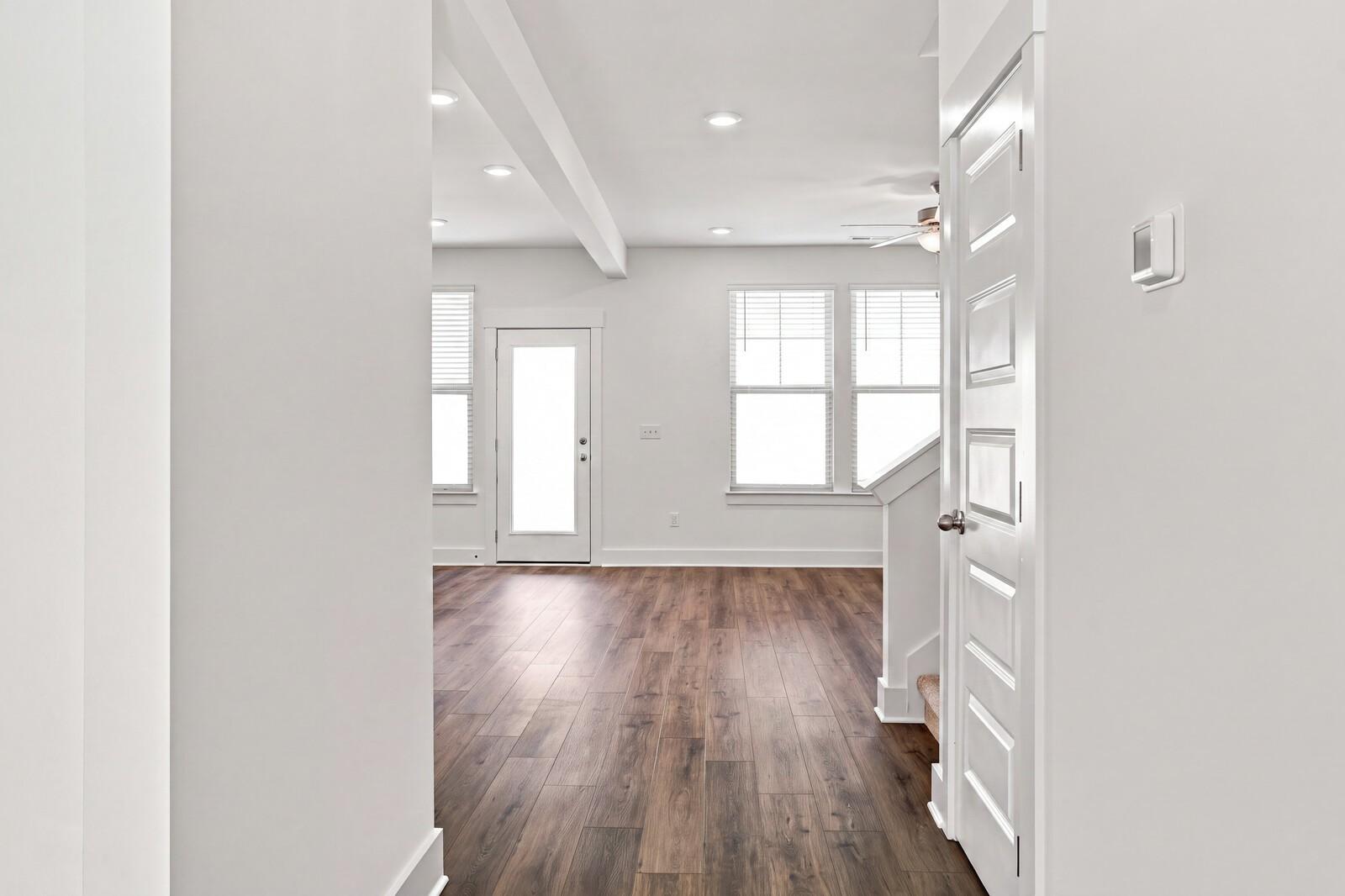 Bright open-concept living area with hardwood floors and recessed lighting in Davidson Homes Willow C plan, Gallatin, Tennessee