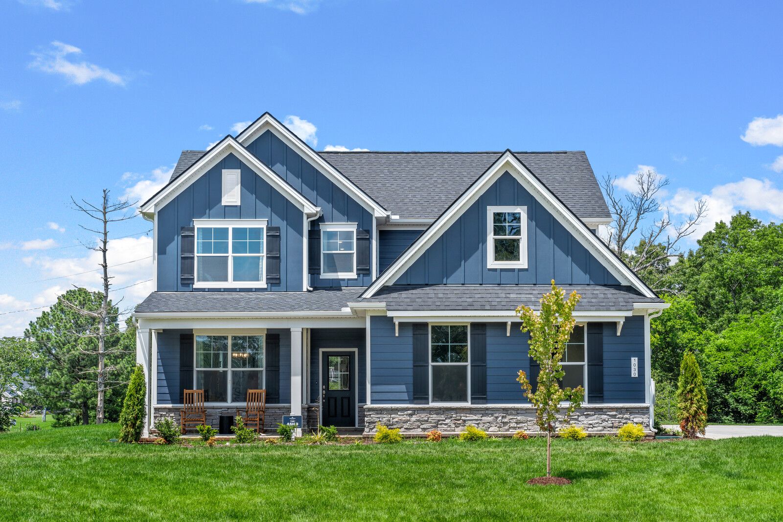 Blue farmhouse exterior at Benders Cove in Mt. Juliet, Tennessee, built by Davidson Homes with a covered front porch.