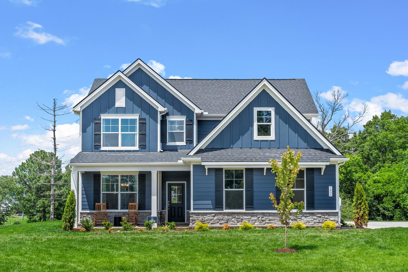 Blue farmhouse exterior at Benders Cove in Mt. Juliet, Tennessee, built by Davidson Homes with a covered front porch.