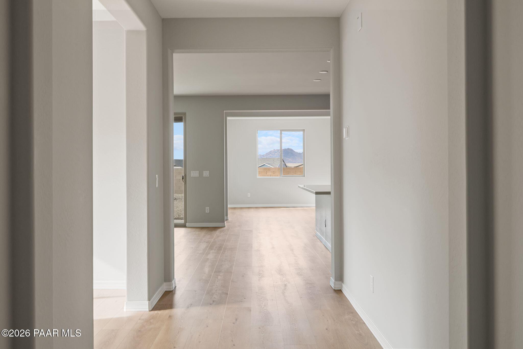 Open-concept hallway leading to spacious living area in The Inspiration A floor plan at North Ridge, Prescott Valley.