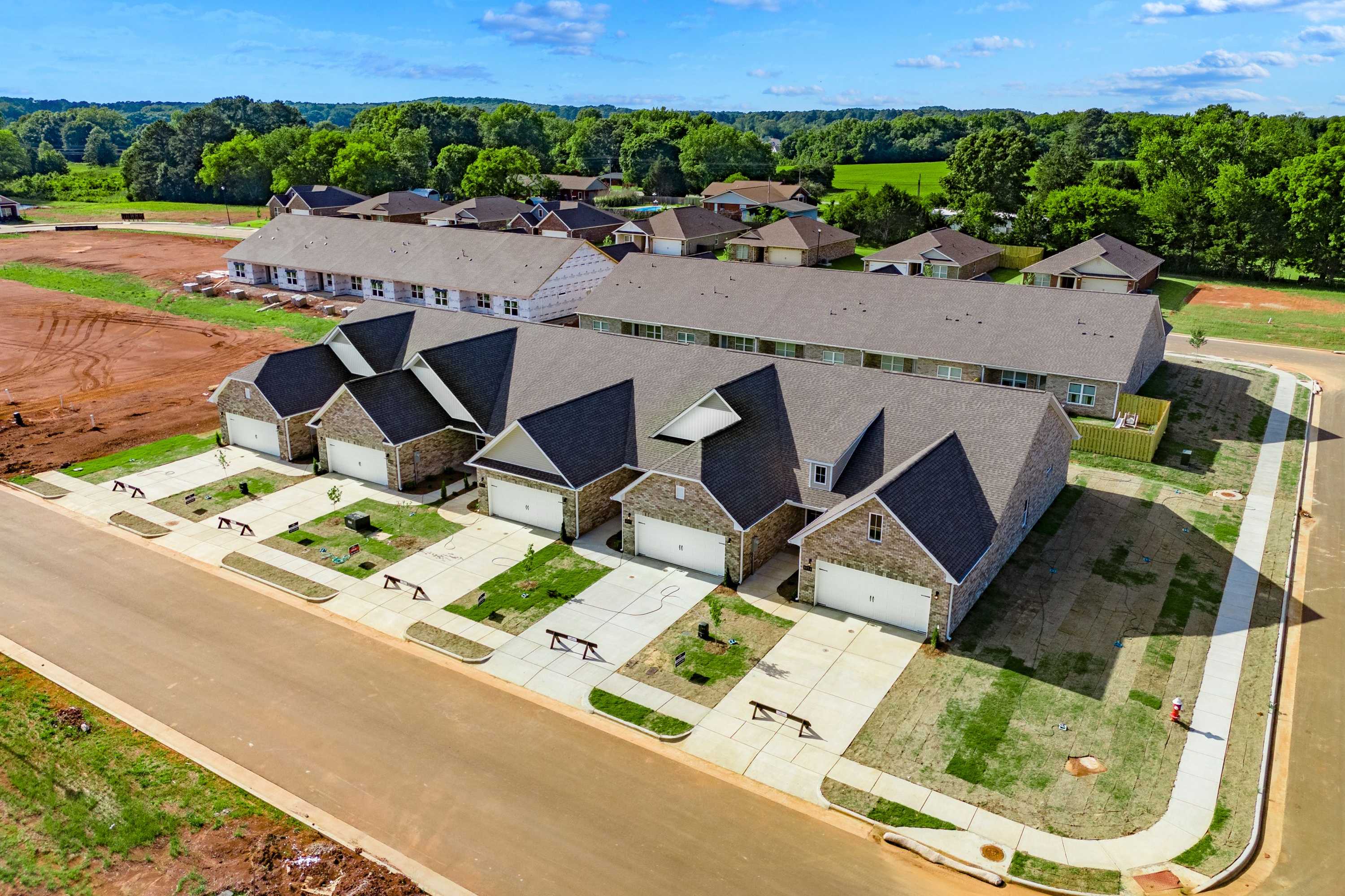 Aerial view of new townhomes with garages and driveways at The Retreat at Hollon Meadow in Decatur, Alabama