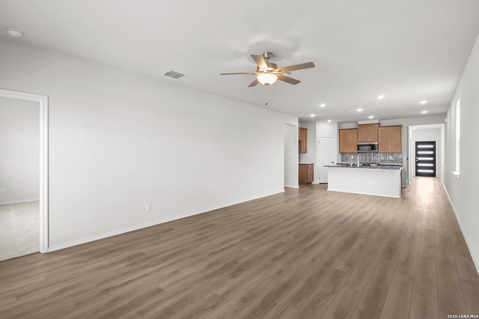 Open-concept living room and kitchen in The San Marcos F floor plan by Davidson Homes in Rayburn Valley, San Antonio.