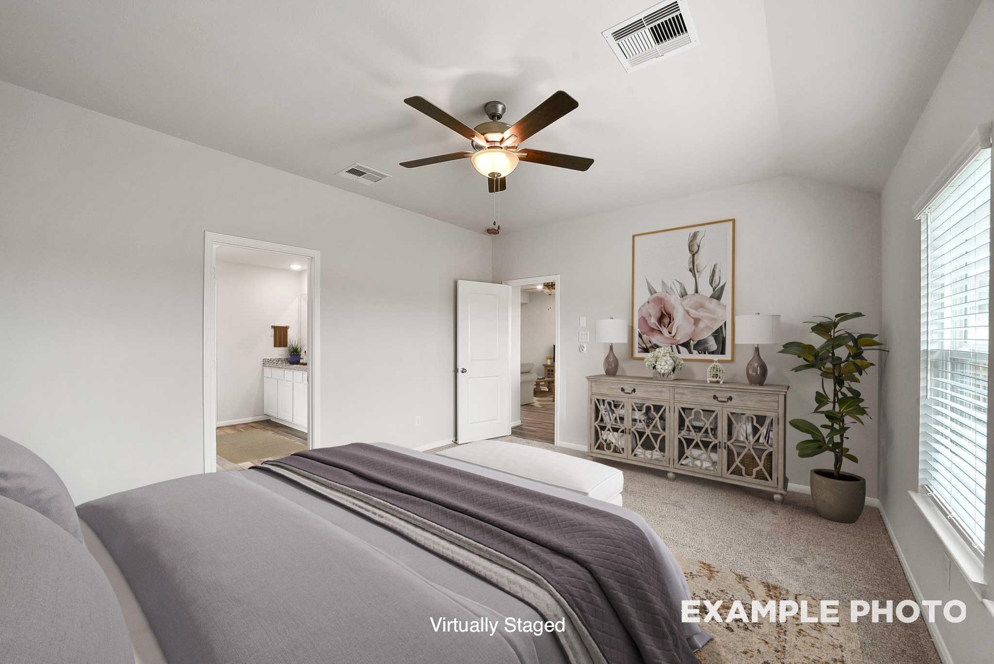 Serene master bedroom with ceiling fan, king bed, dresser, and artwork in Davidson Homes The Tierra B, Beasley, Texas