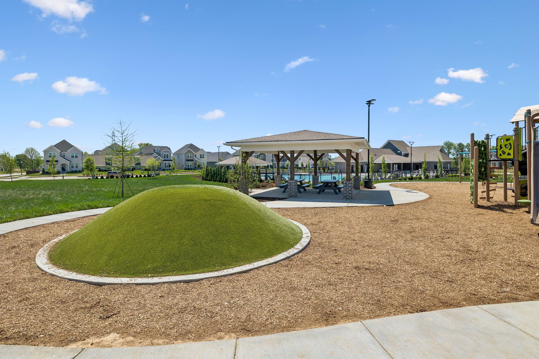 Community playground with artificial turf hill and covered picnic pavilion at Bradshaw Farms in Mt. Juliet, Tennessee.