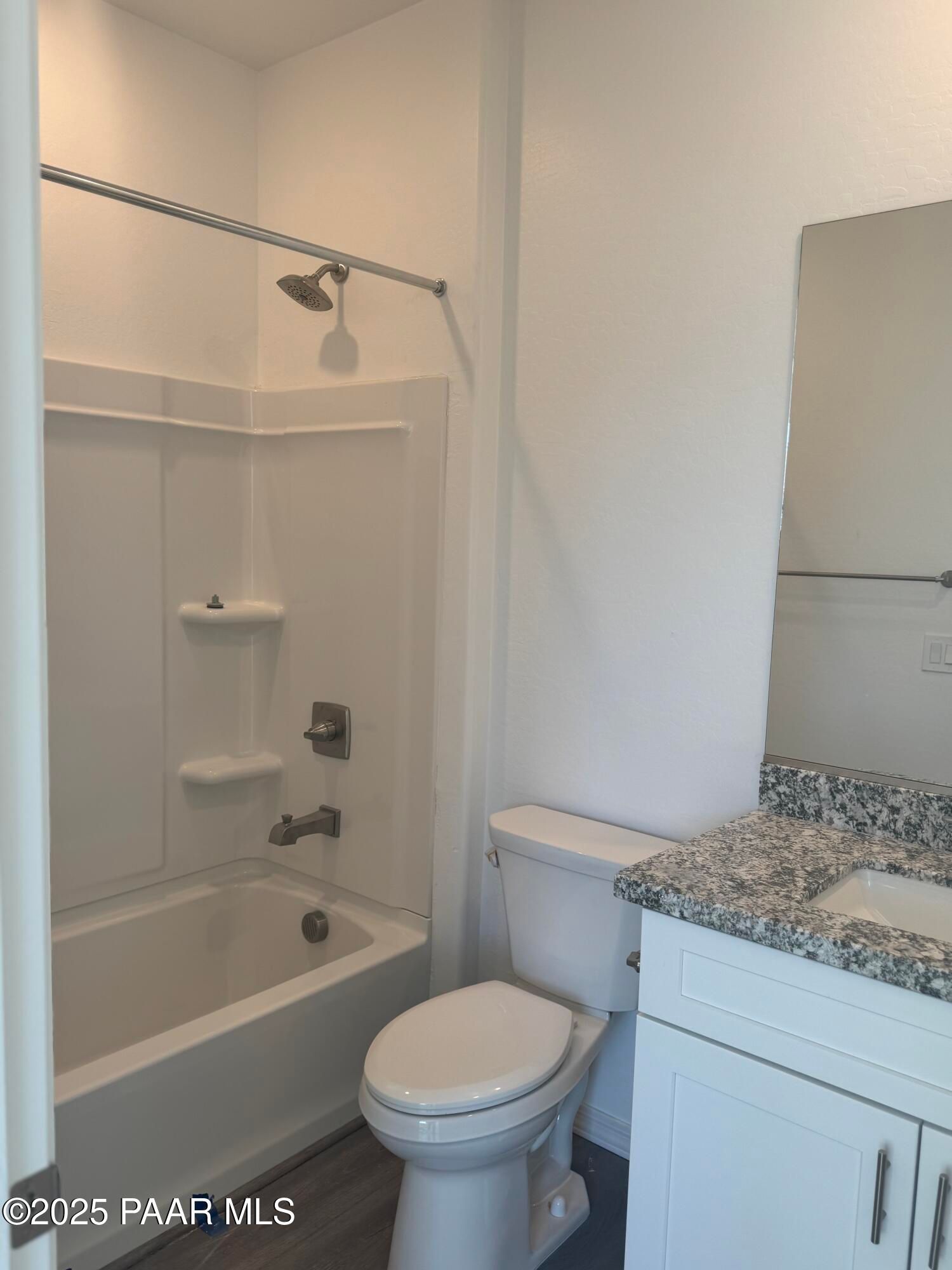 Modern master bathroom featuring walk-in shower, deep soaking tub, granite vanity, and large mirror in Davidson Homes The Summit A, Prescott, Arizona