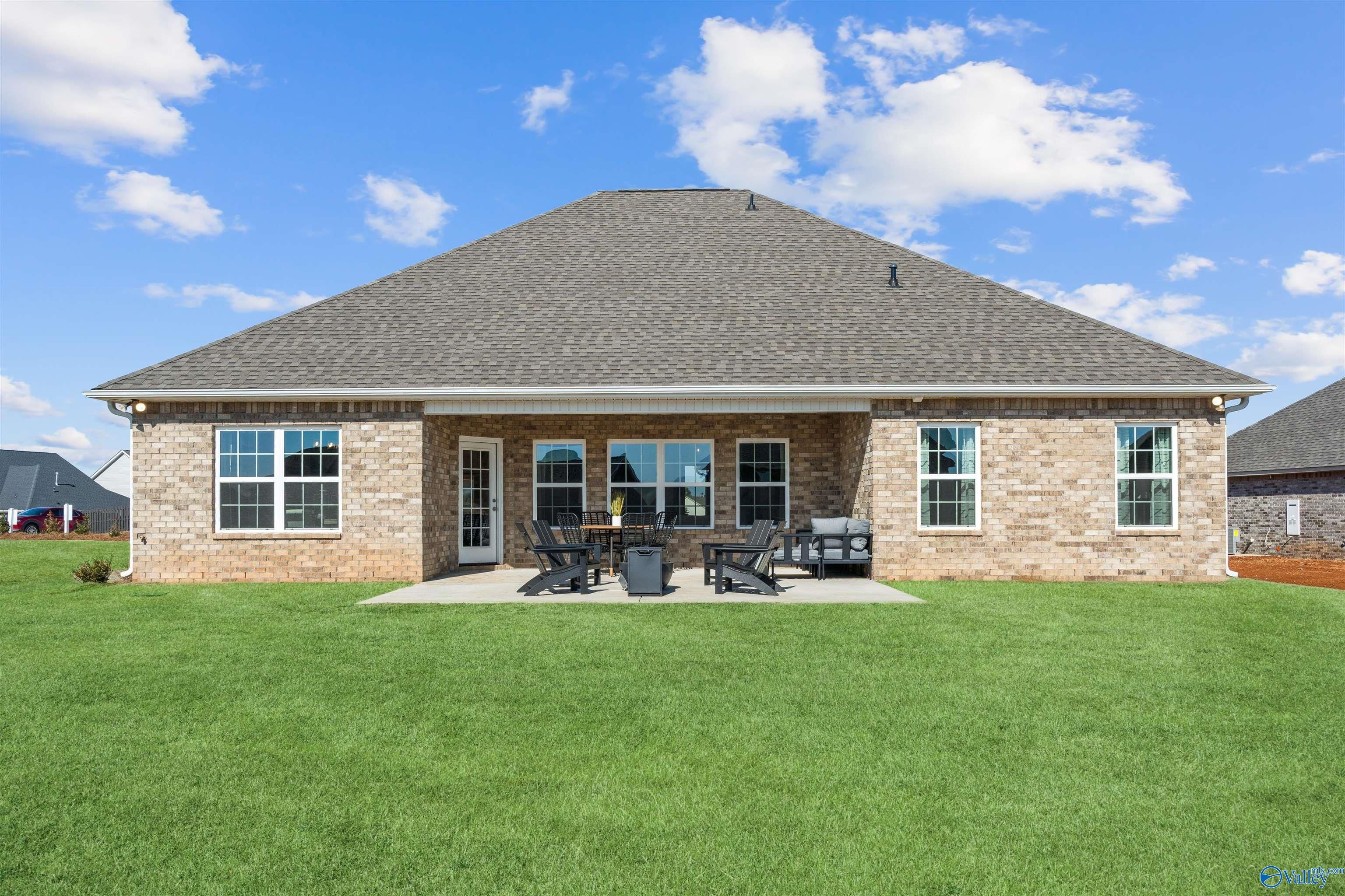 Covered back patio with glass doors and outdoor seating in Davidson Homes The Rockford B, Madison, Alabama