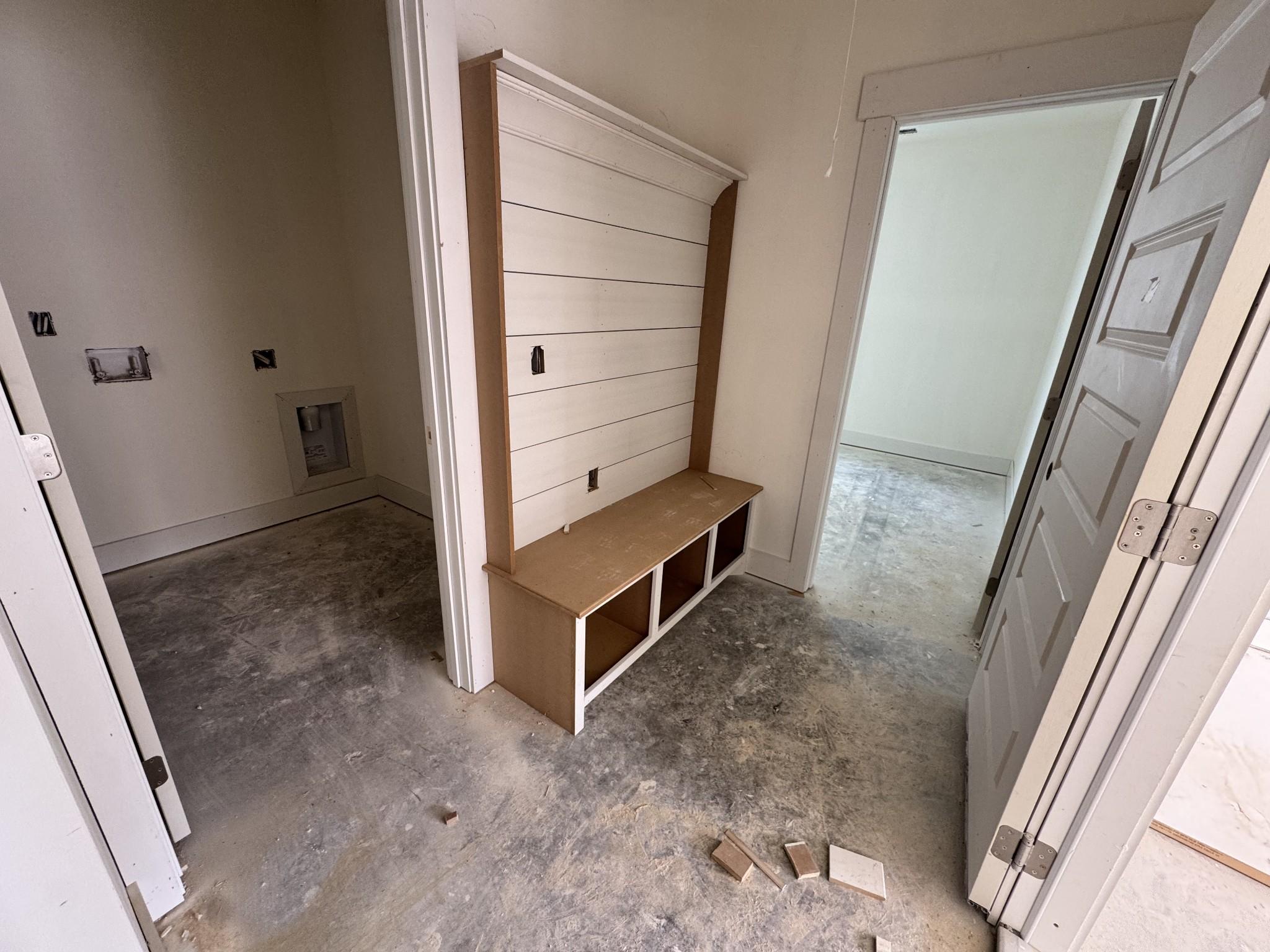 Built-in mudroom bench with shiplap hooks and storage cubbies in Davidson Homes Cottonwood E, Gallatin, Tennessee
