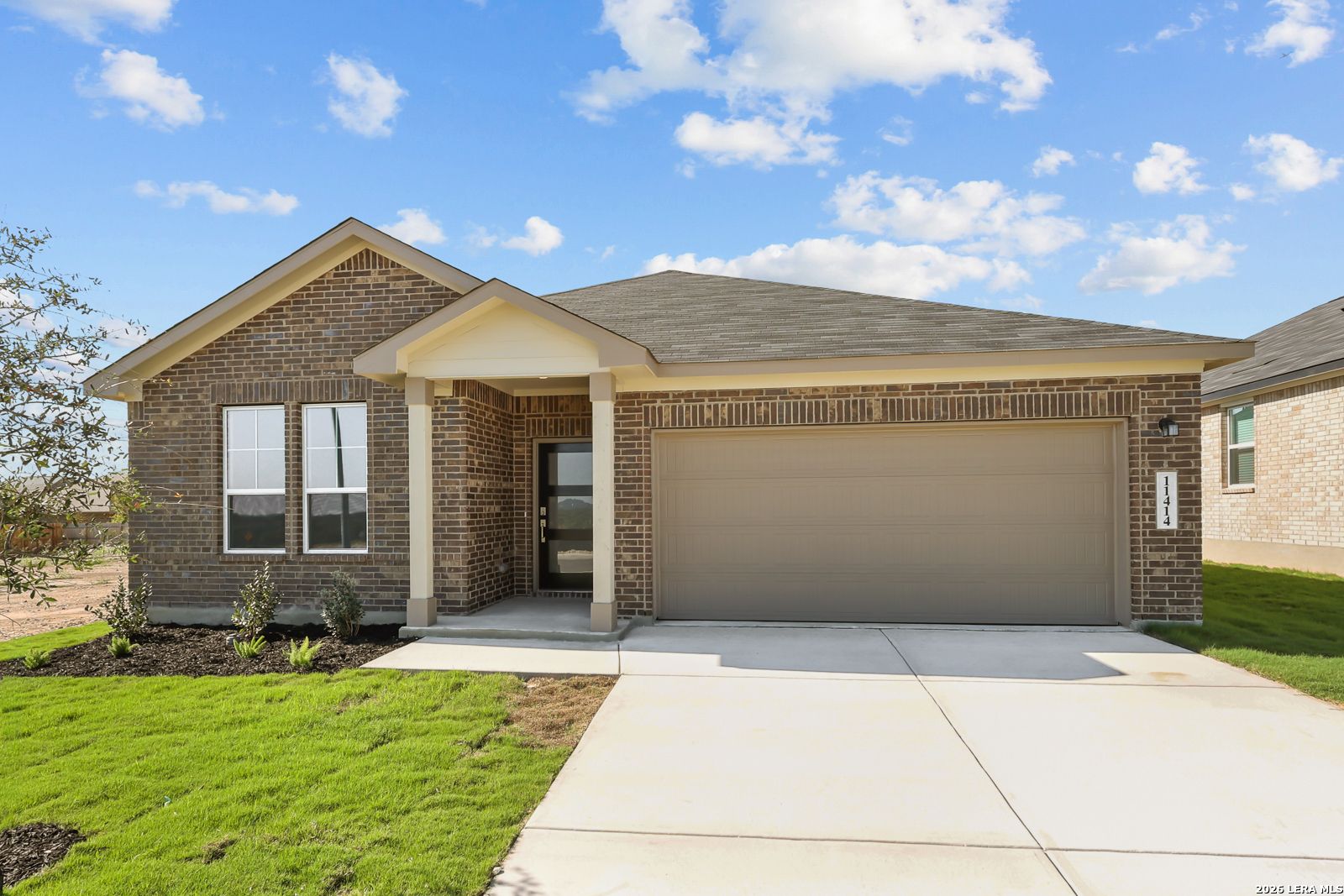 Brick exterior front of The Daphne I, 4-bed single-story home with 2-car garage by Davidson Homes in Bricewood, San Antonio