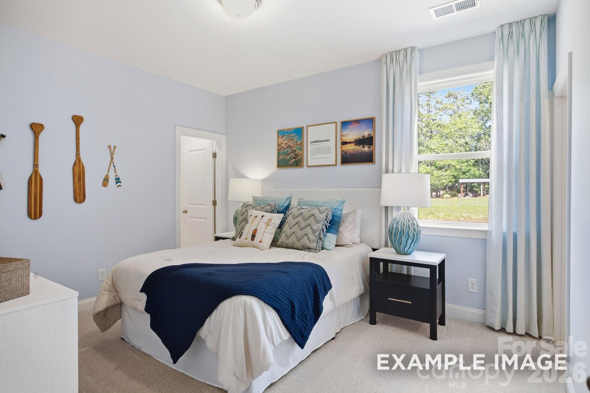 Cozy bedroom with nautical decor in The Hickory B II floor plan at Windgate, Mooresville, North Carolina.