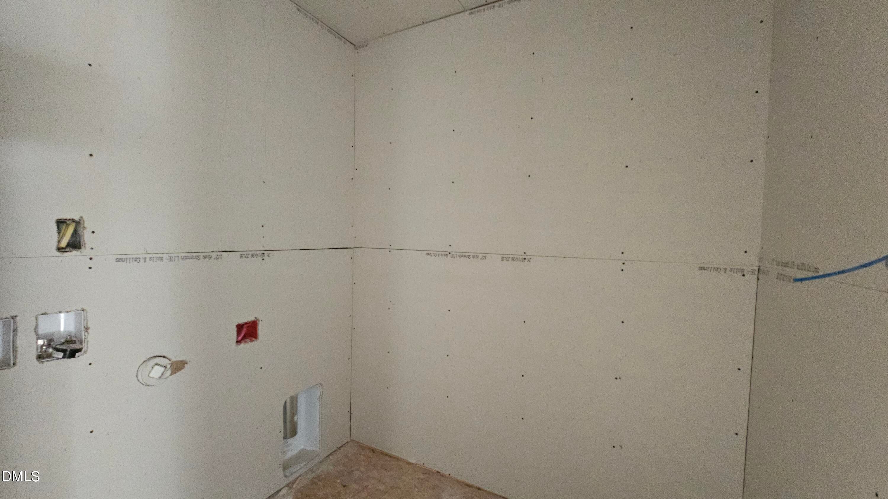 Unfinished laundry room with drywall installation in The Graham floor plan at Springvale, Fuquay-Varina, North Carolina.