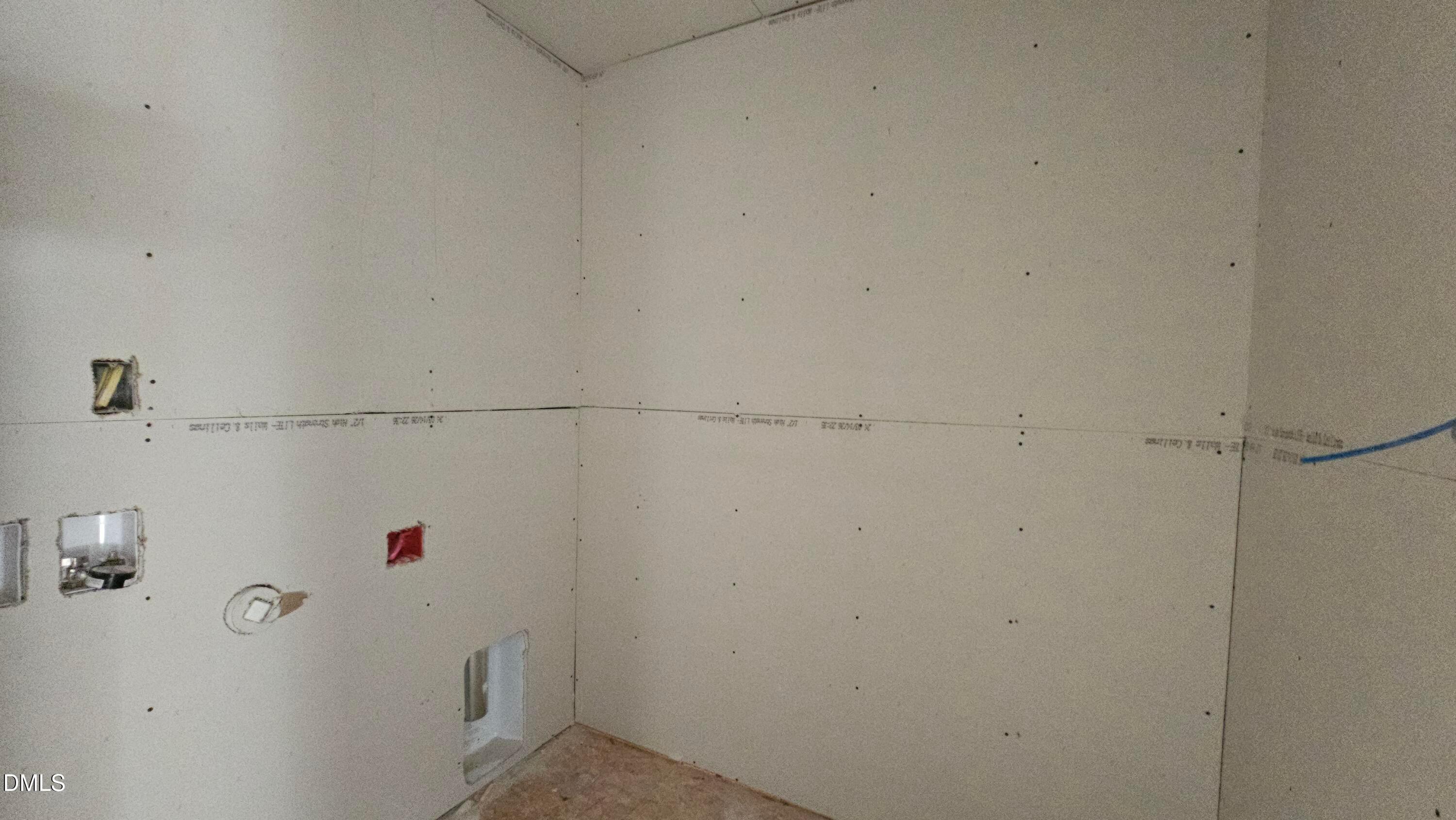 Unfinished laundry room with drywall installation in The Graham floor plan at Springvale, Fuquay-Varina, North Carolina.
