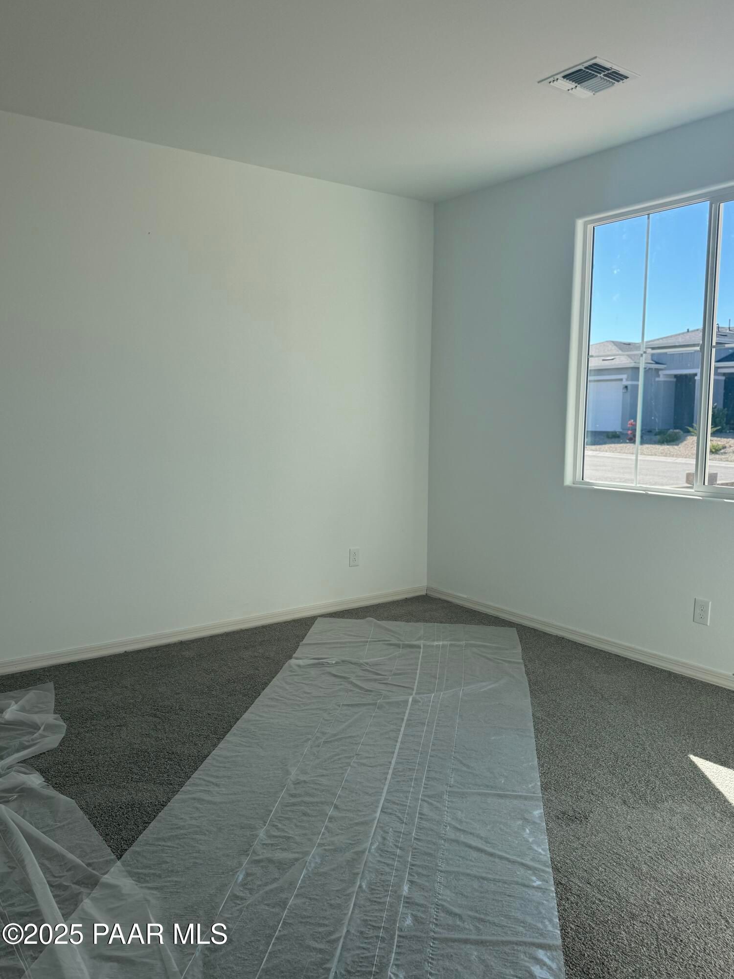 Empty secondary bedroom with large window overlooking neighborhood in Davidson Homes The Summit A, Prescott, Arizona