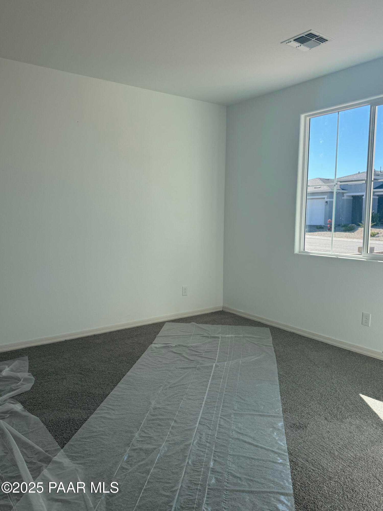 Empty secondary bedroom with large window overlooking neighborhood in Davidson Homes The Summit A, Prescott, Arizona