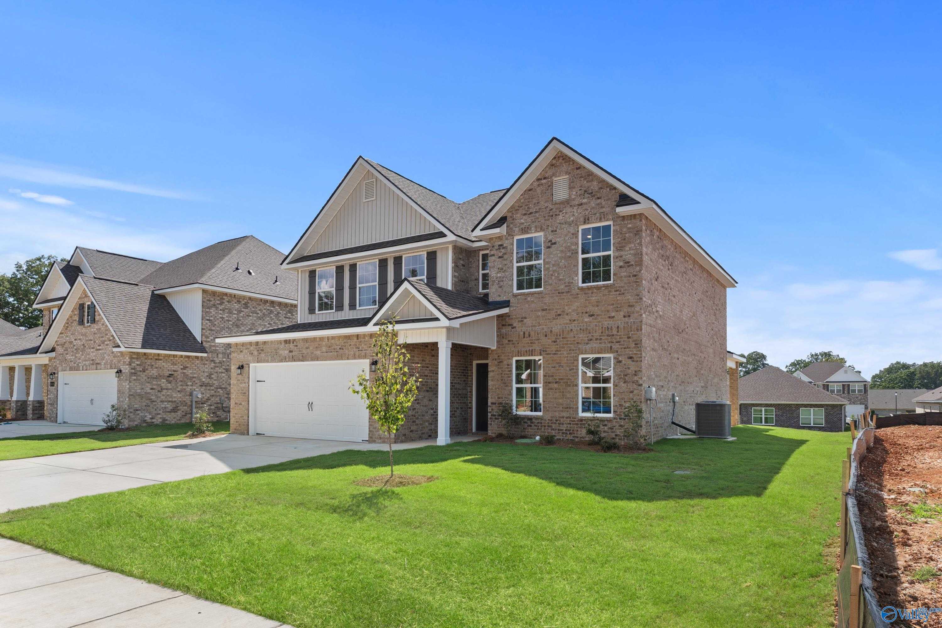 Two-story brick home with 2-car garage, front porch, and lush lawn in Creek Grove, New Market, Alabama - Davidson Homes Shelby A