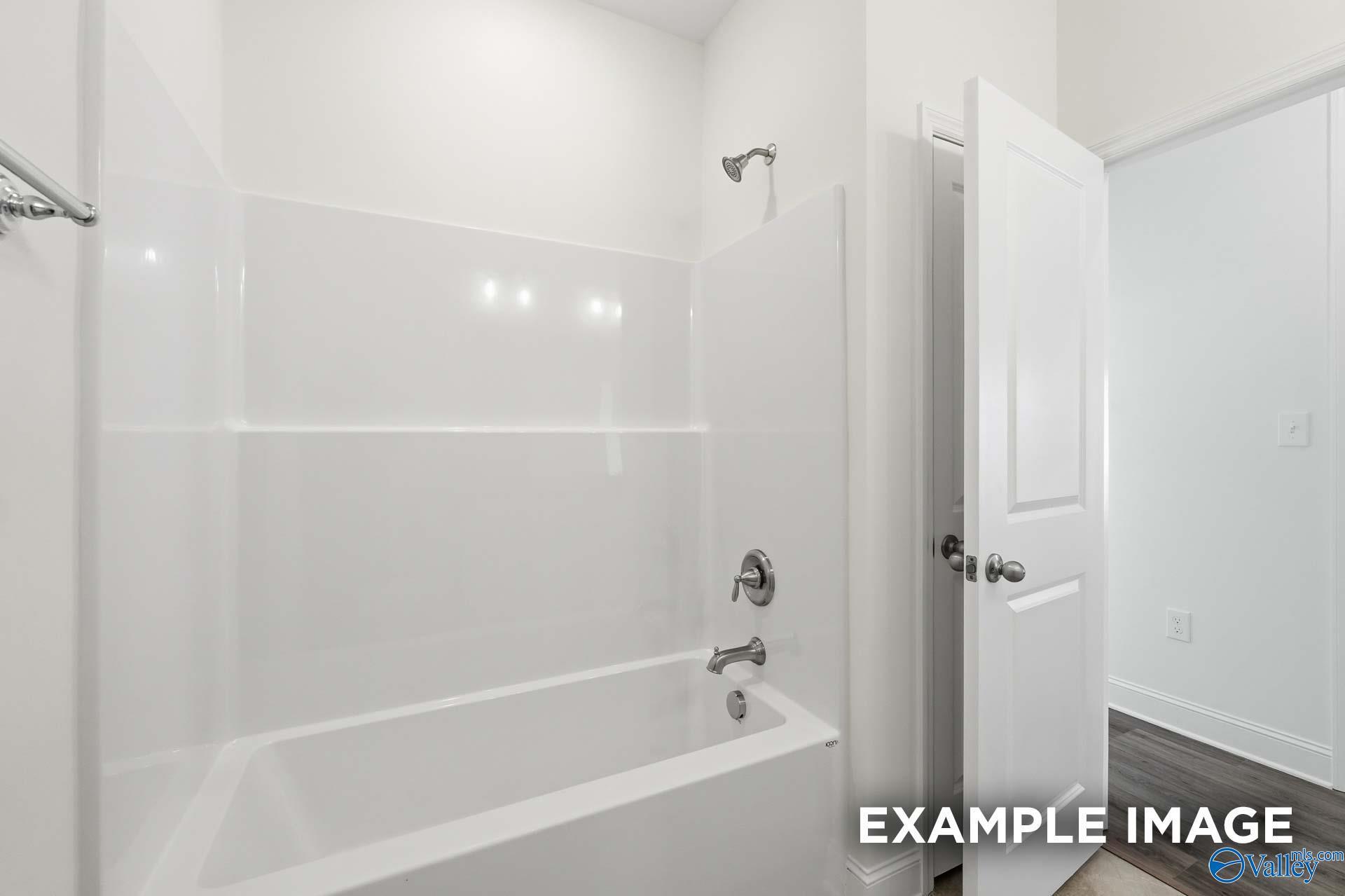 Bright white bathtub and shower combination in The Valencia floor plan by Davidson Homes in Briercreek, Meridianville, AL.