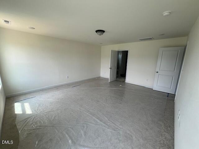 Spacious neutral bedroom with carpet protection in The Hickory II B floor plan at Retreat at North Main, Lillington, NC.