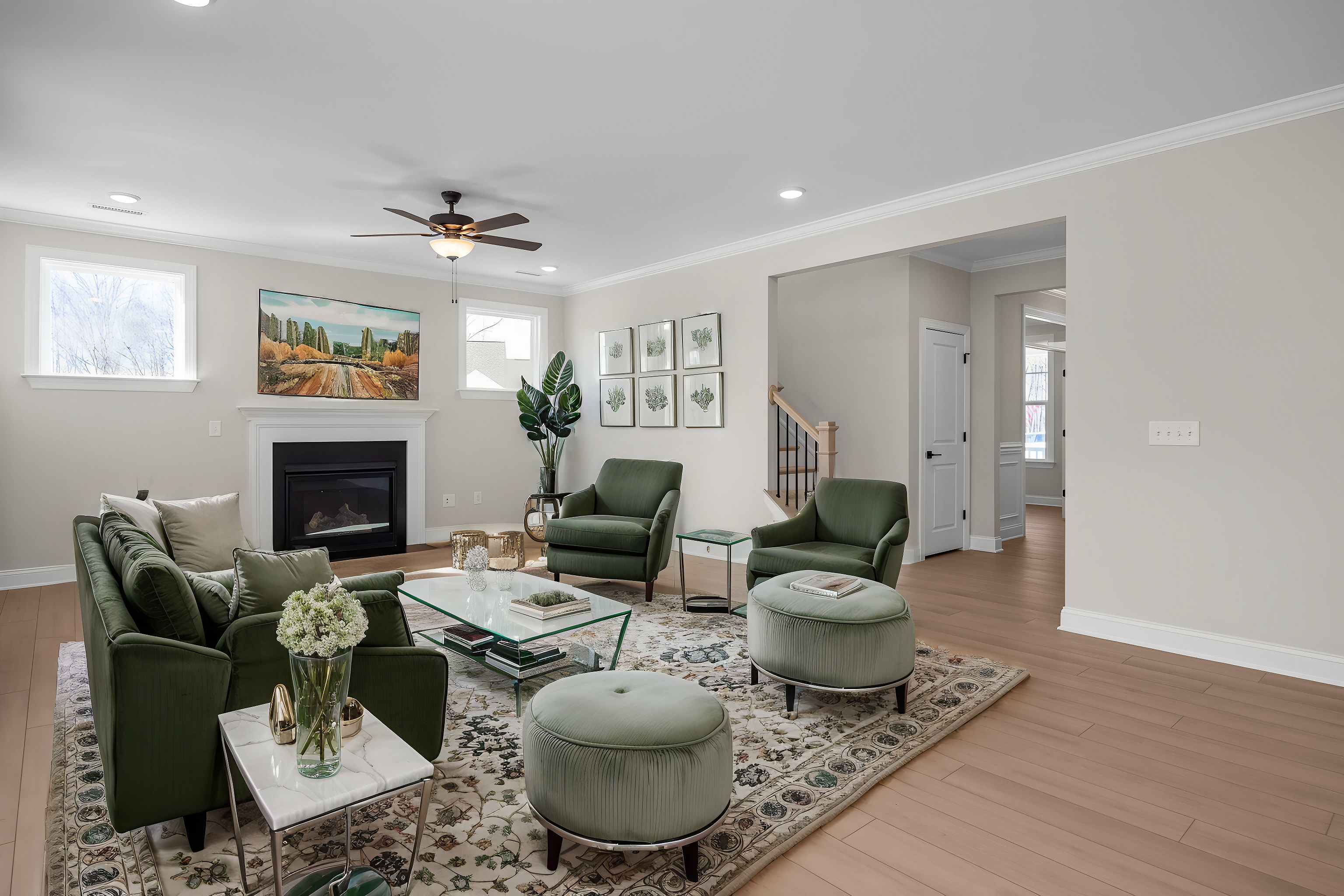 Cozy living room at Enclave at Belmont in Belmont NC with green velvet chairs, fireplace, Tuscan landscape painting, and potted plants