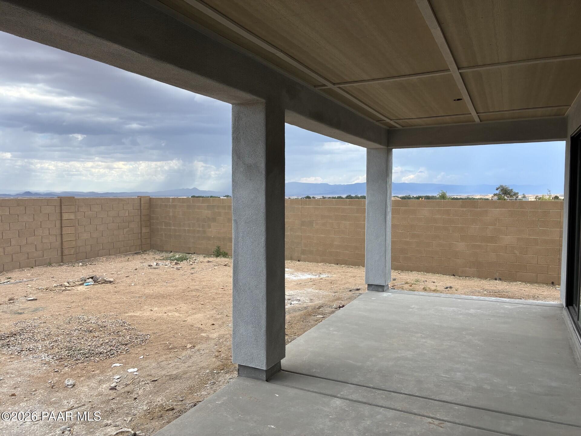 Covered patio with mountain views in a new Davidson Homes Durango II G floor plan at South Ranch, Prescott, Arizona.
