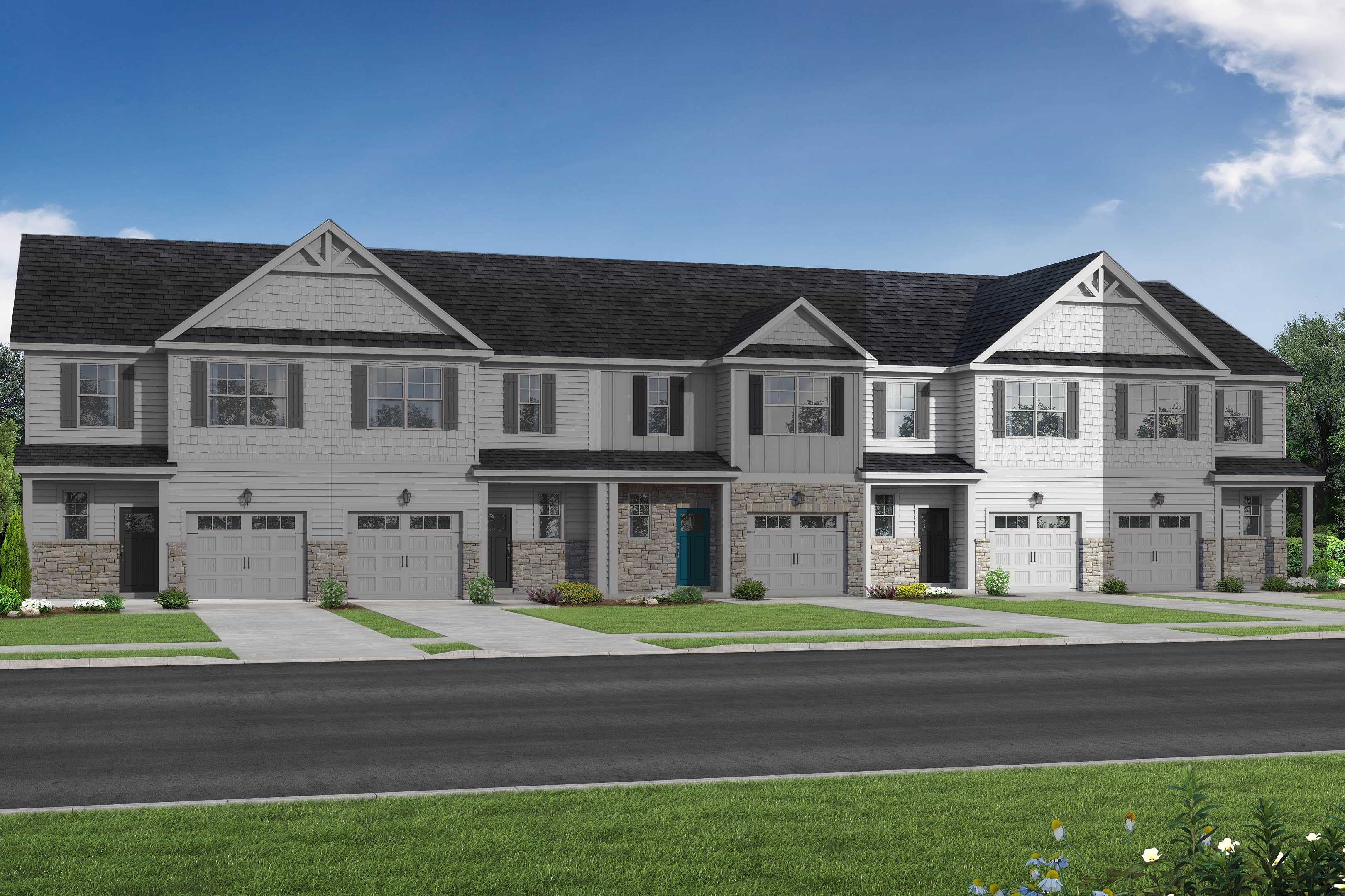Row of modern 2-story The Graham multi-family townhomes in Fuquay-Varina, NC, featuring white siding, dark gabled roofs, 1-car garages, and landscaped yards