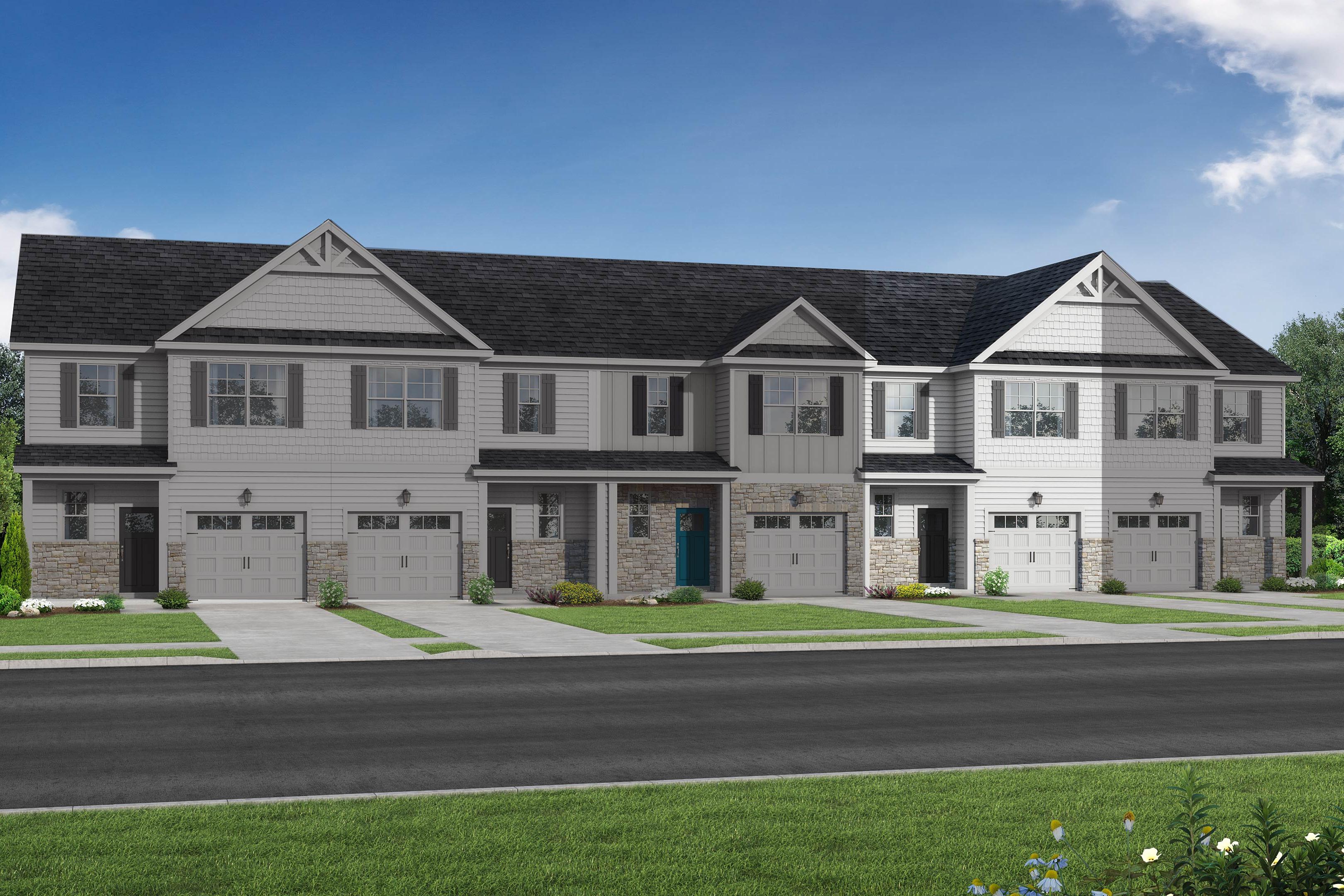 Row of modern 2-story The Graham multi-family townhomes in Fuquay-Varina, NC, featuring white siding, dark gabled roofs, 1-car garages, and landscaped yards