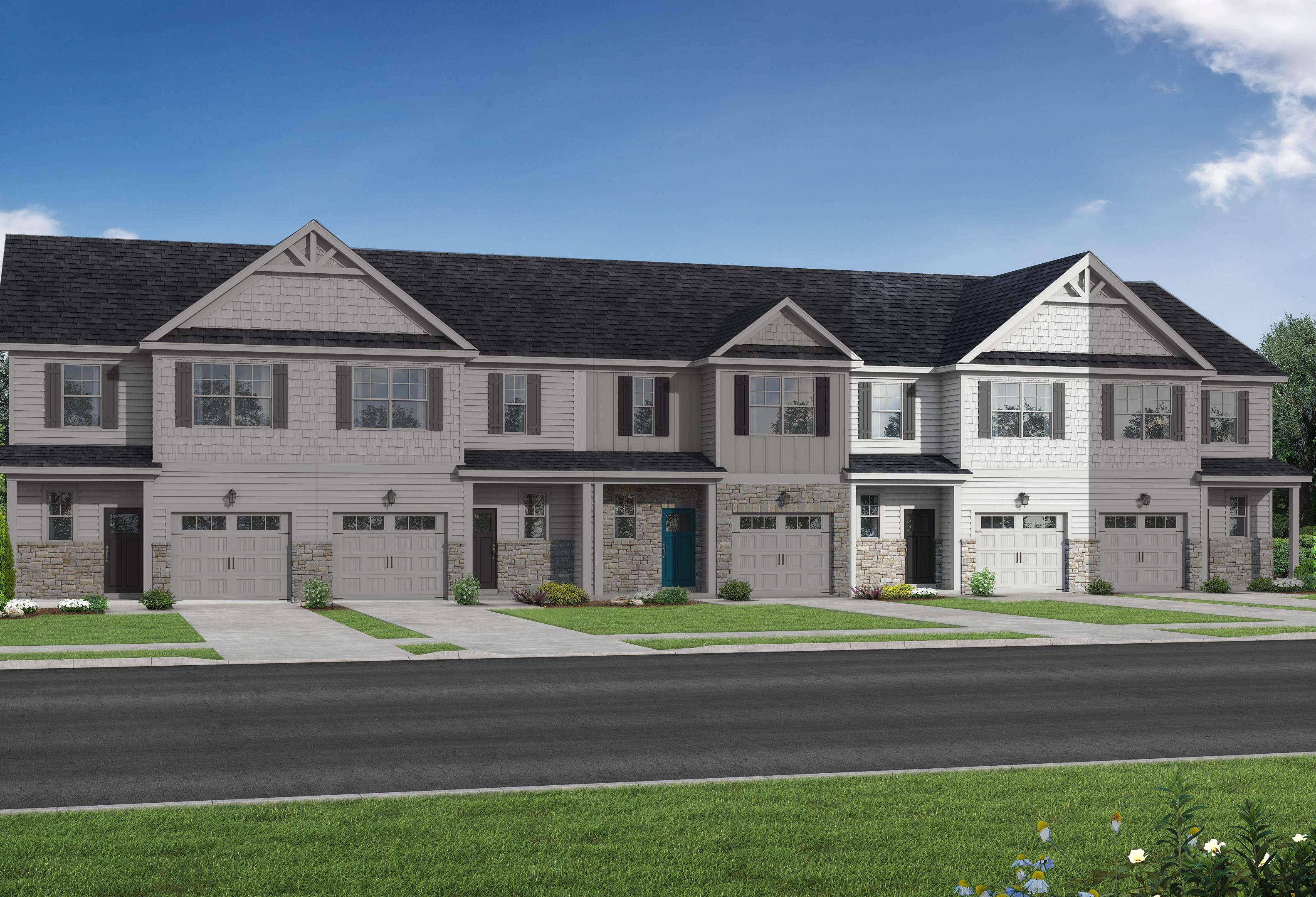 Row of modern 2-story The Graham multi-family townhomes in Fuquay-Varina, NC, featuring white siding, dark gabled roofs, 1-car garages, and landscaped yards