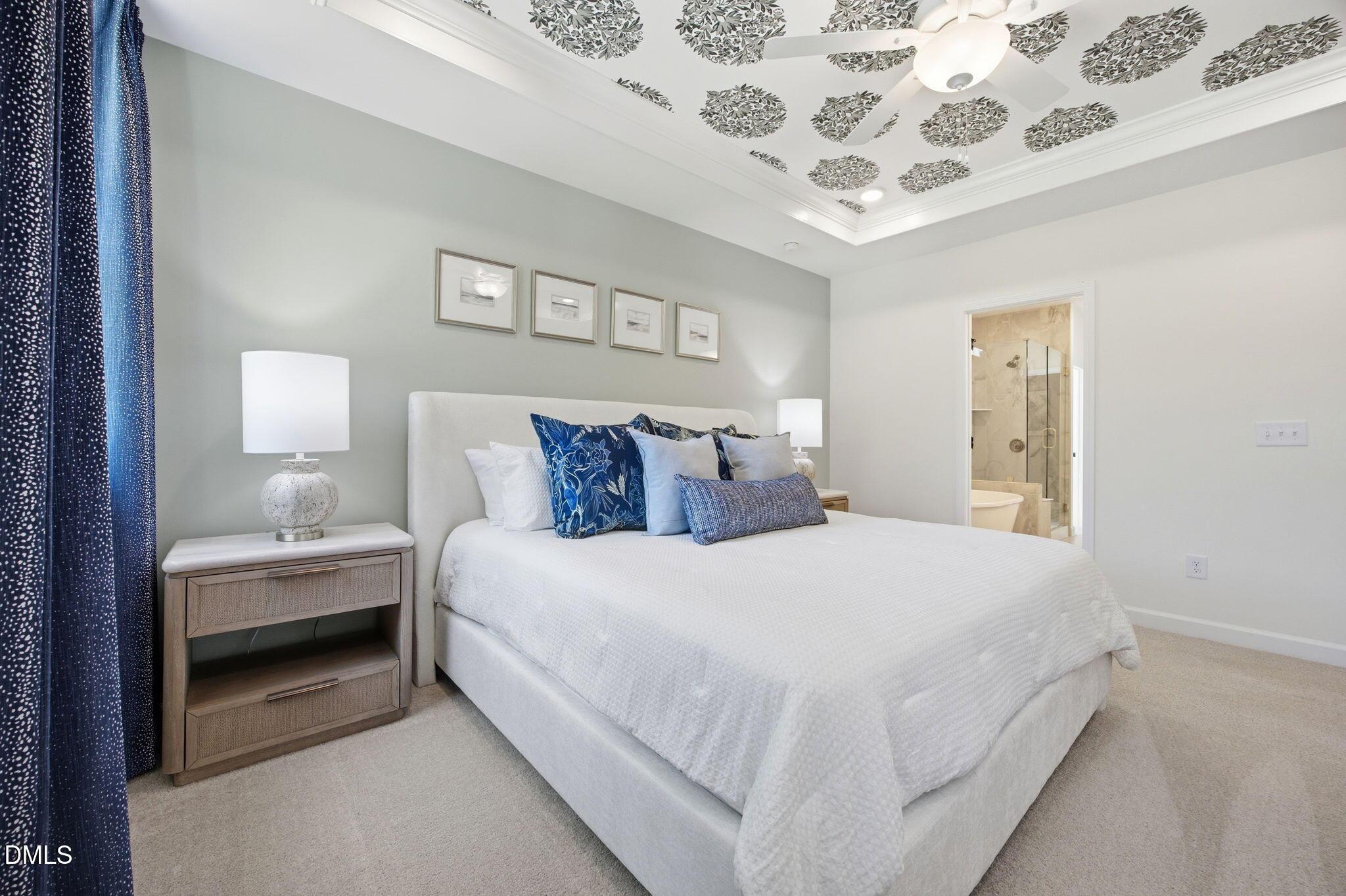 Primary bedroom with floral tray ceiling in The Ashport M floor plan at Wendell Ridge, Wendell, North Carolina.