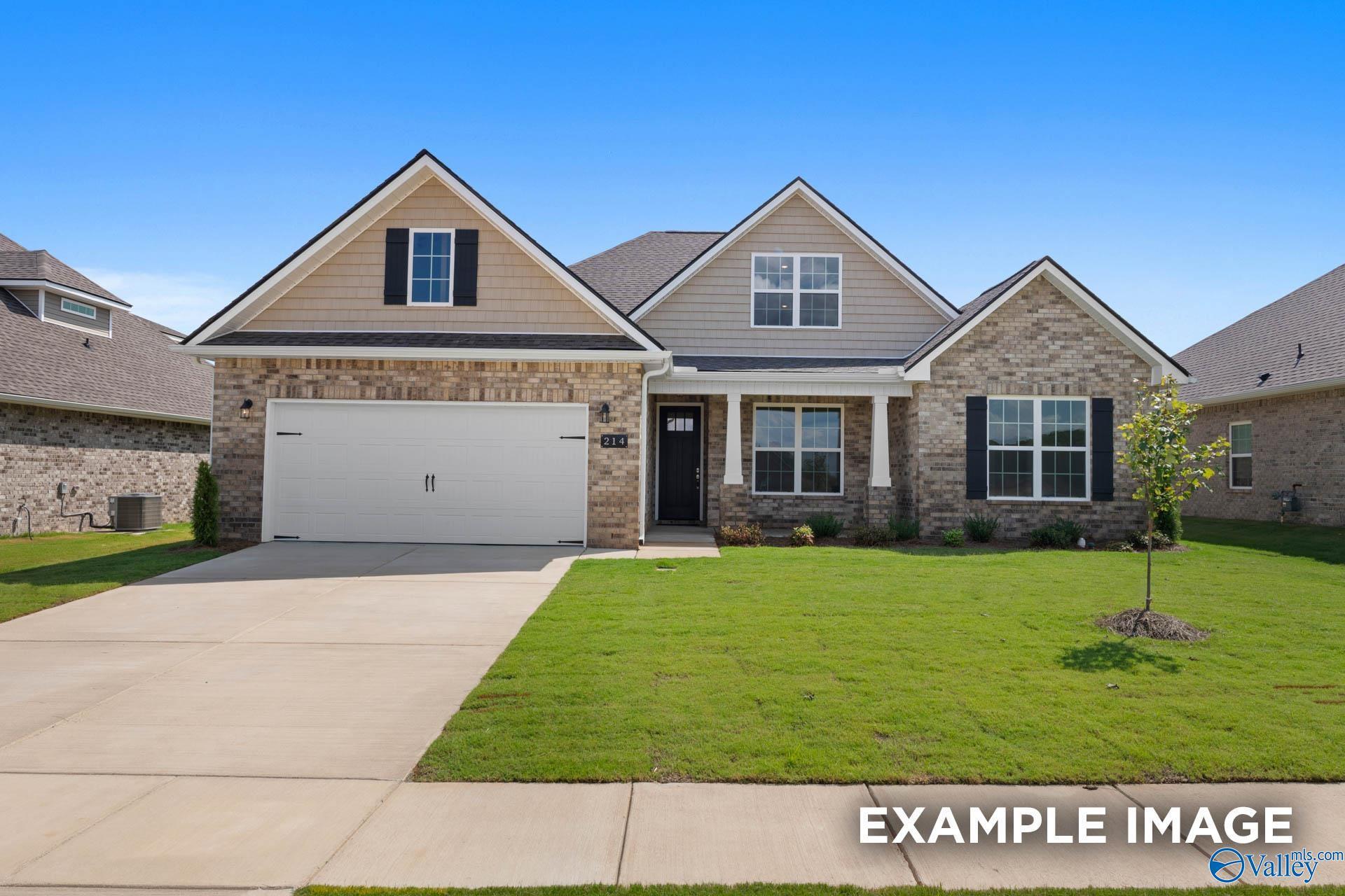 Modern 1-story brick and siding home with 2-car garage, covered porch, and lush lawn in The Meadows, Athens, Alabama by Davidson Homes Rockford B