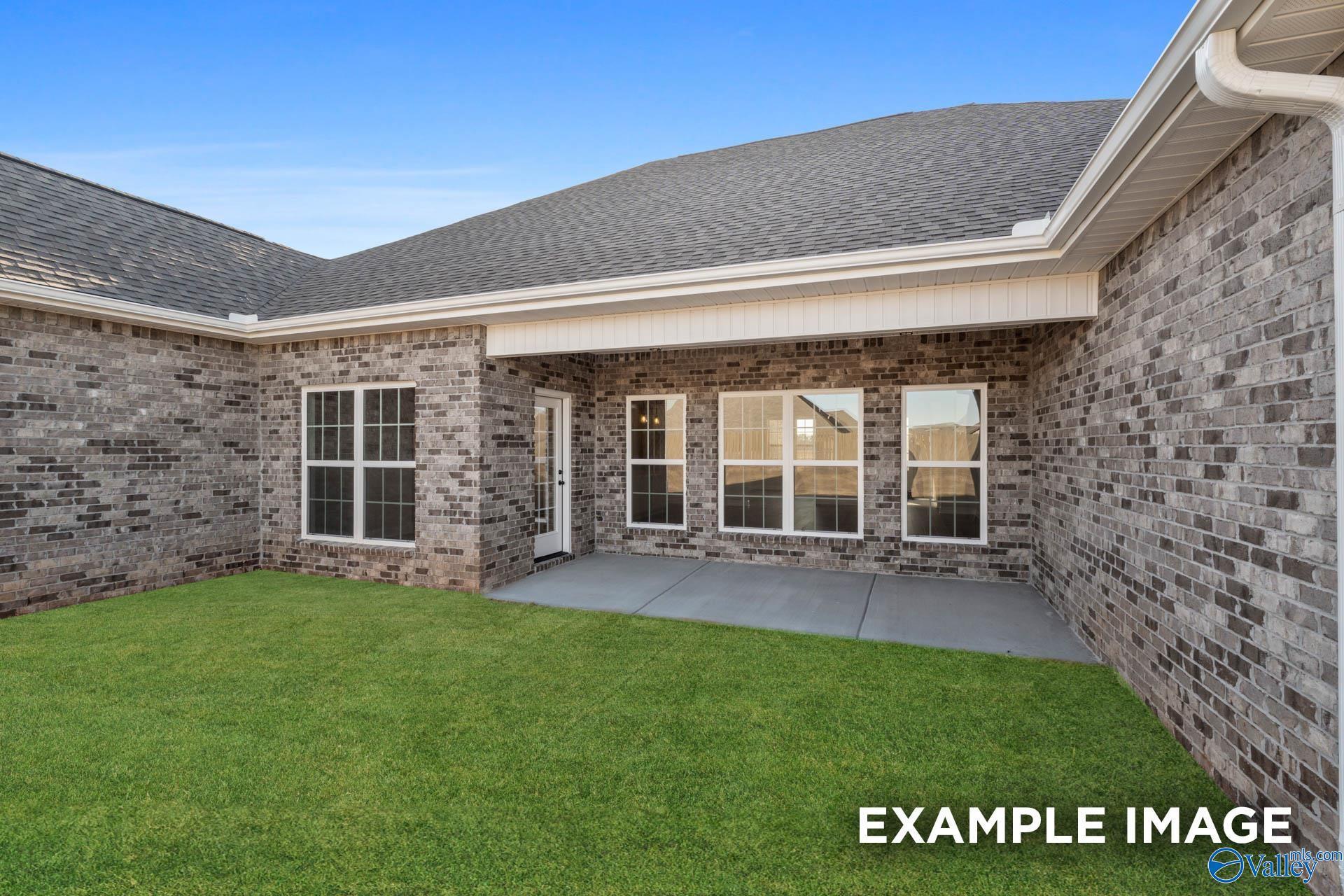 Covered concrete patio and backyard of The Valencia floor plan by Davidson Homes in Briercreek, Meridianville, Alabama.