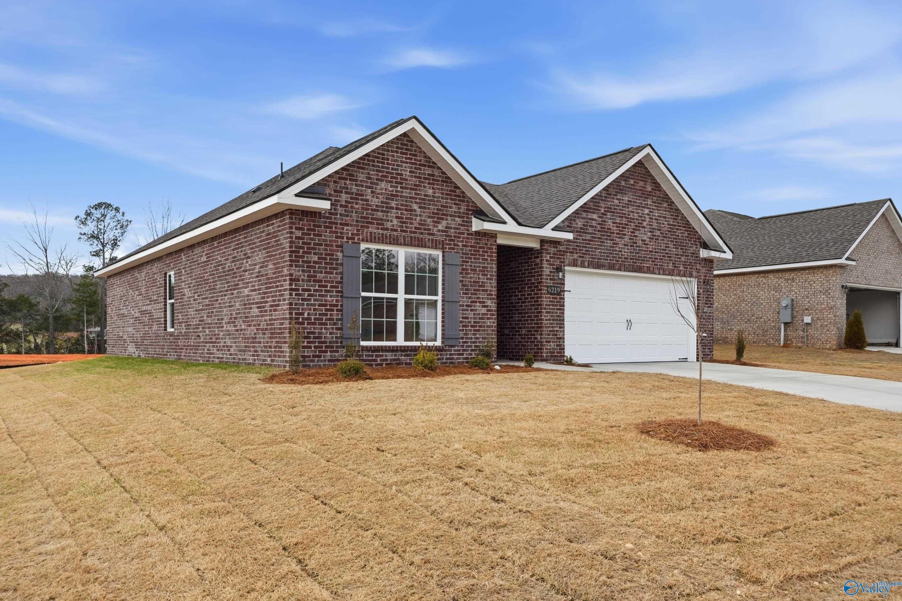 Single-story brick ranch home with 2-car garage and landscaped yard, The Asheville C by Davidson Homes in Spragins Cove, Huntsville, Alabama