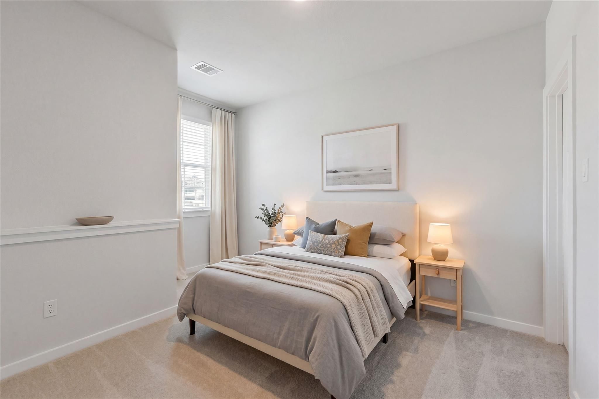 Cozy neutral-toned bedroom with queen bed, pillows, lamps, and window in Davidson Homes The Colorado F, Cleveland, Texas