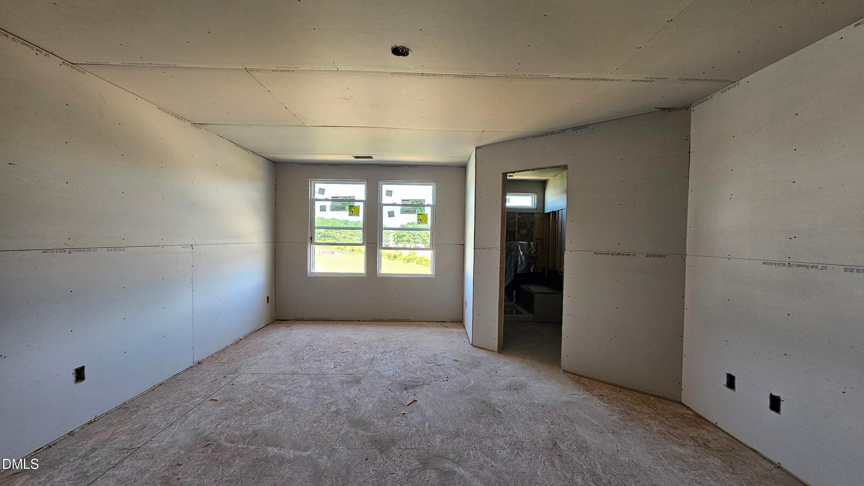 Unfinished master bedroom with drywall in The Graham floor plan by Davidson Homes at Springvale in Fuquay-Varina, NC.