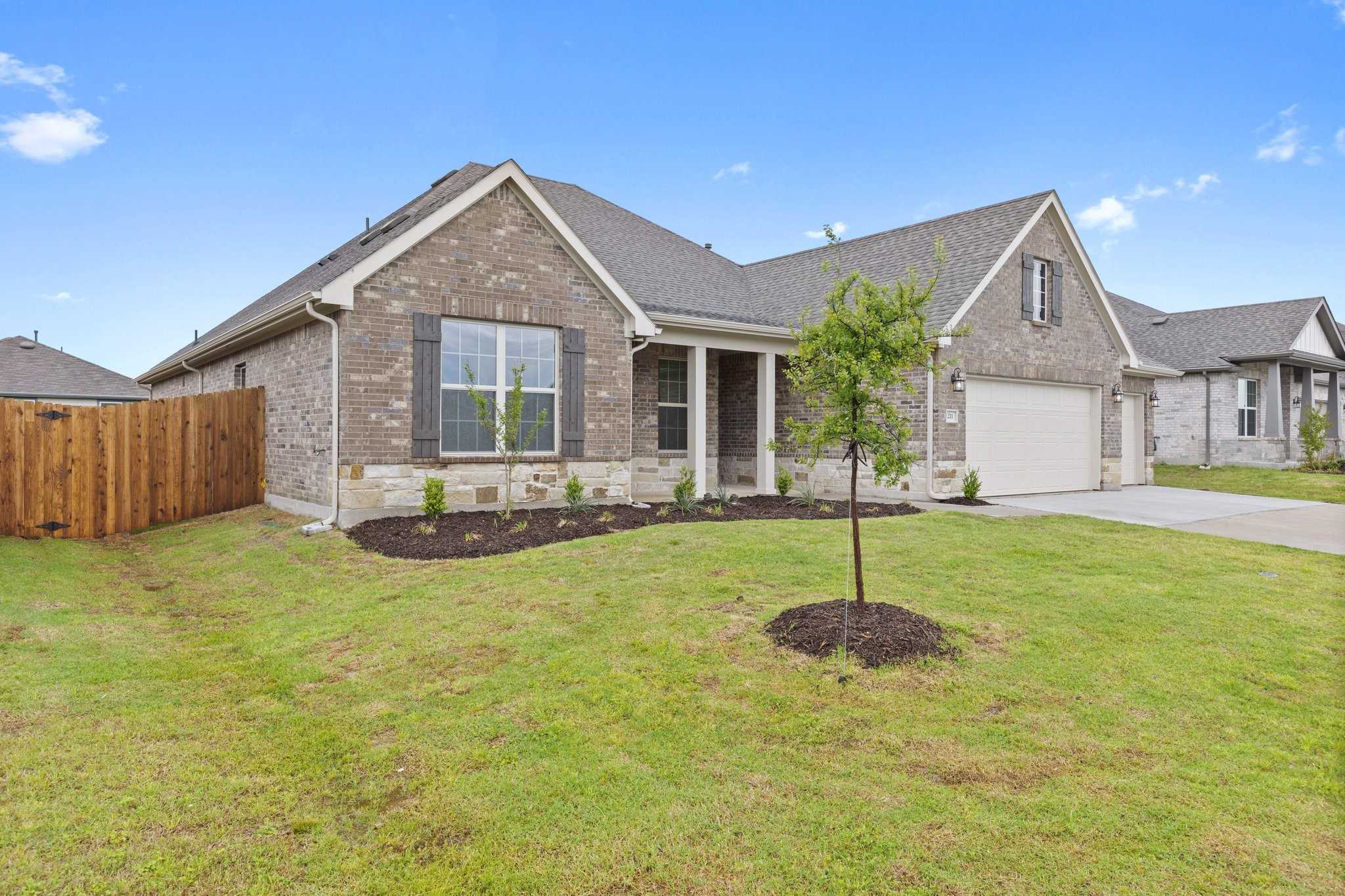 Brick 1-story home with 3-car garage, front porch, and landscaped yard in Waverly Estates, Josephine, Texas - Davidson Homes Rockford C