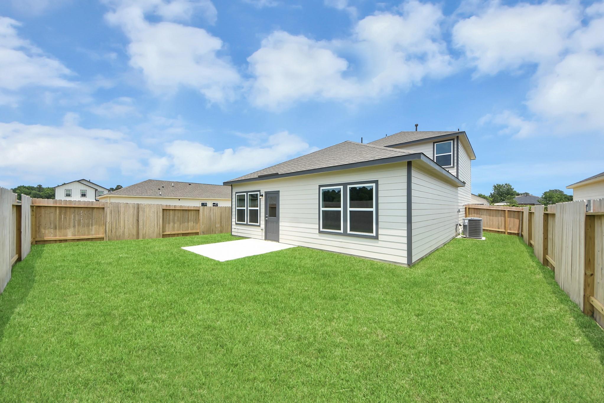 Private fenced backyard and patio of The Blanco E floor plan by Davidson Homes in The Villages at WestPointe, Dayton, TX.