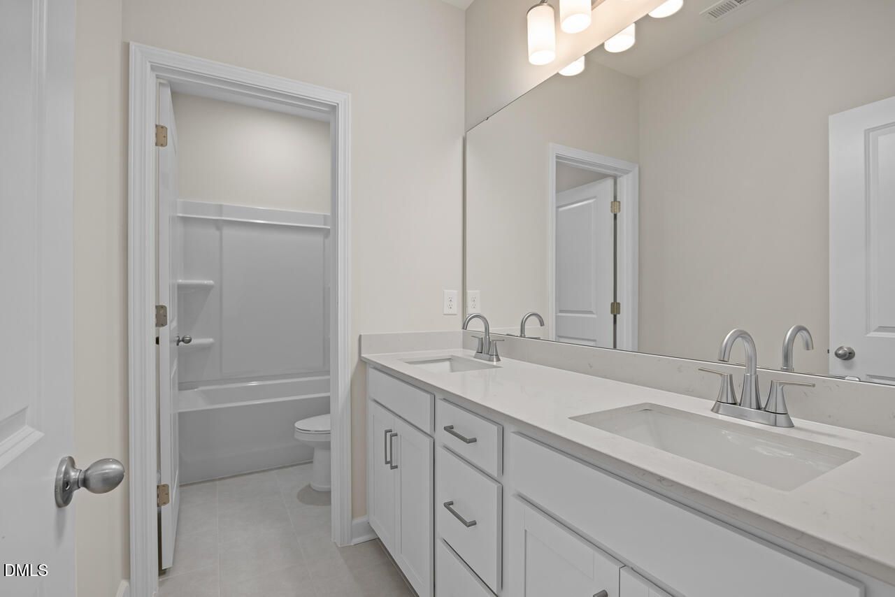 Modern double vanity bathroom with quartz countertops in The Hickory II B floor plan by Davidson Homes in Montrose, Aberdeen.